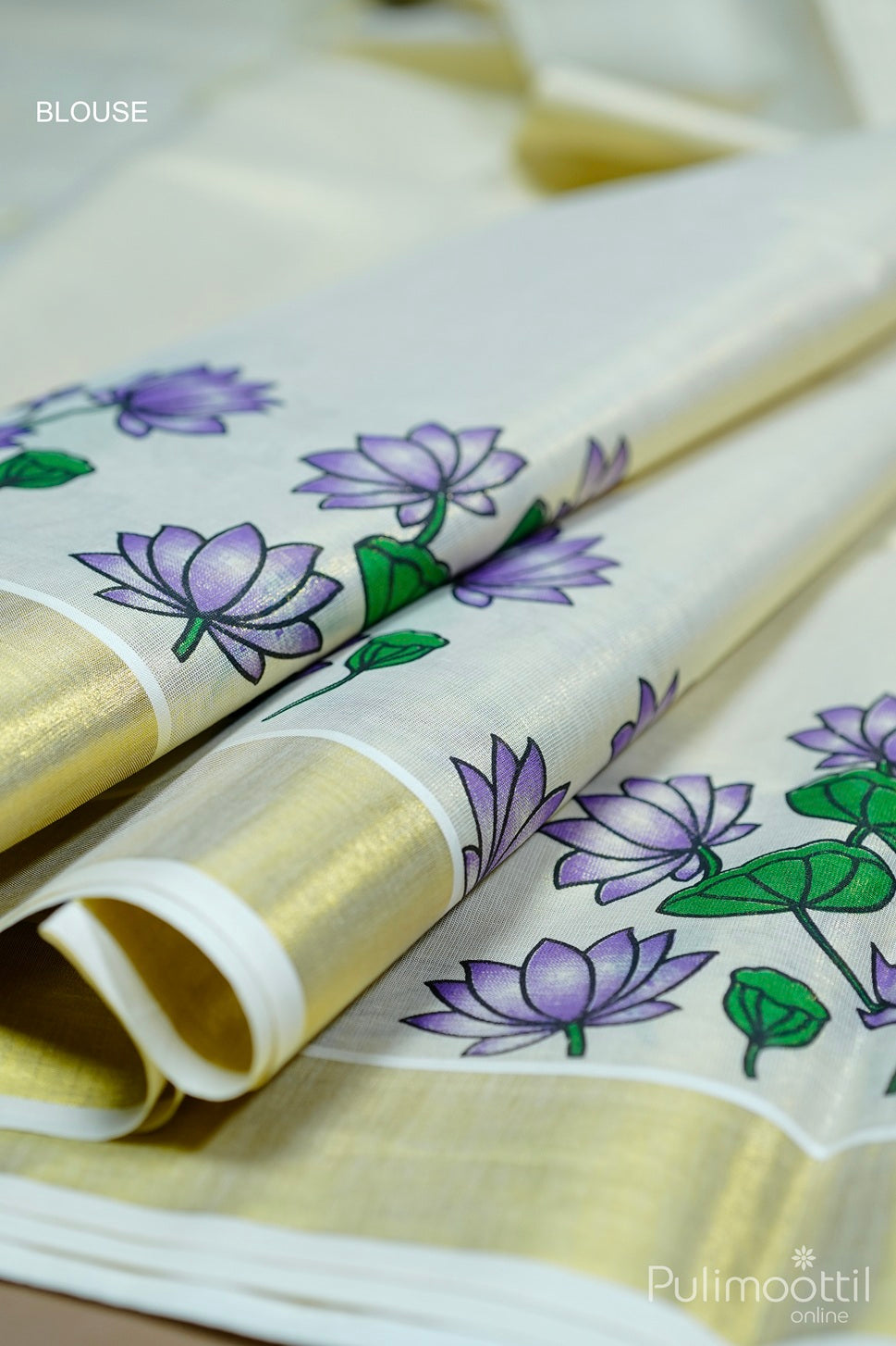 Golden tissue Kerala saree blouse piece with purple lotus floral print and golden border detail