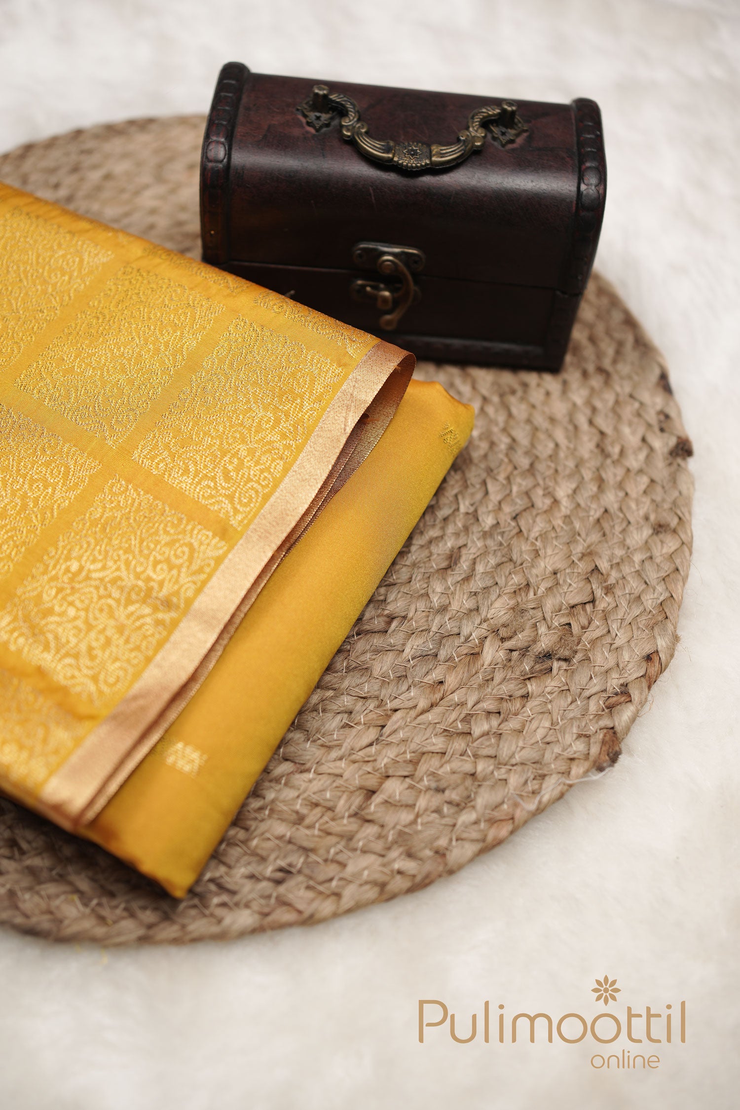 Golden Yellow semi-silk saree with intricate gold zari motifs and a thin copper border, perfect for festive occasions.