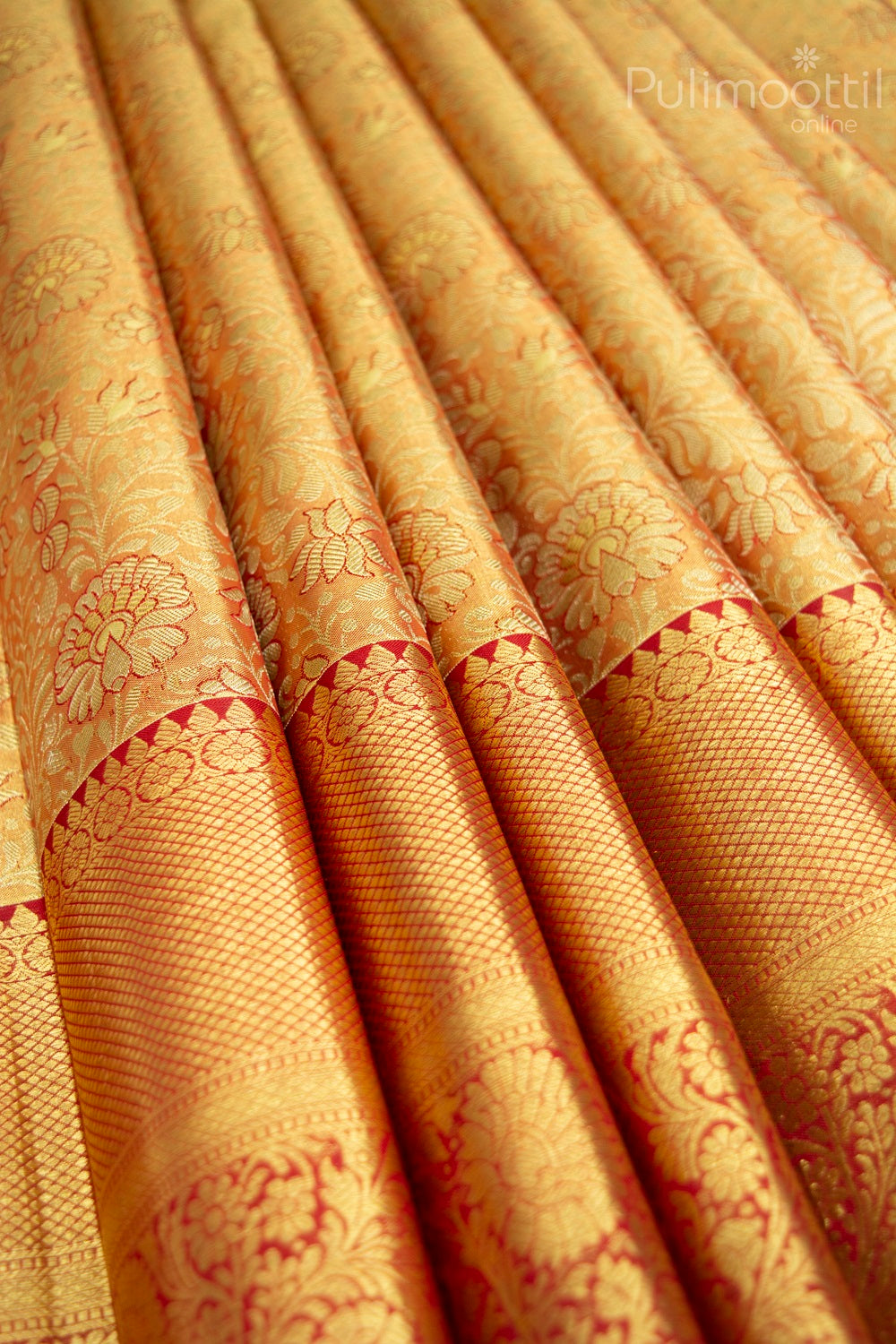 Kanchipuram tissue silk saree with golden zari floral motifs and red contrast border featuring intricate traditional patterns – perfect for bridal and festive wear