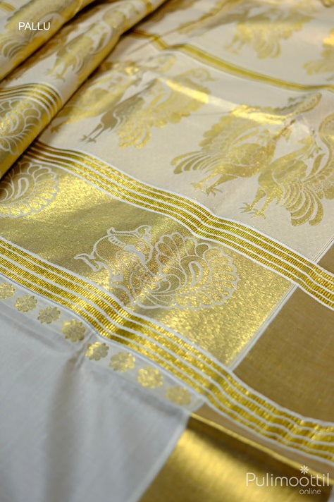 Rich golden zari pallu with peacock and floral motifs in Kerala brocade set saree, bordered in golden tissue.