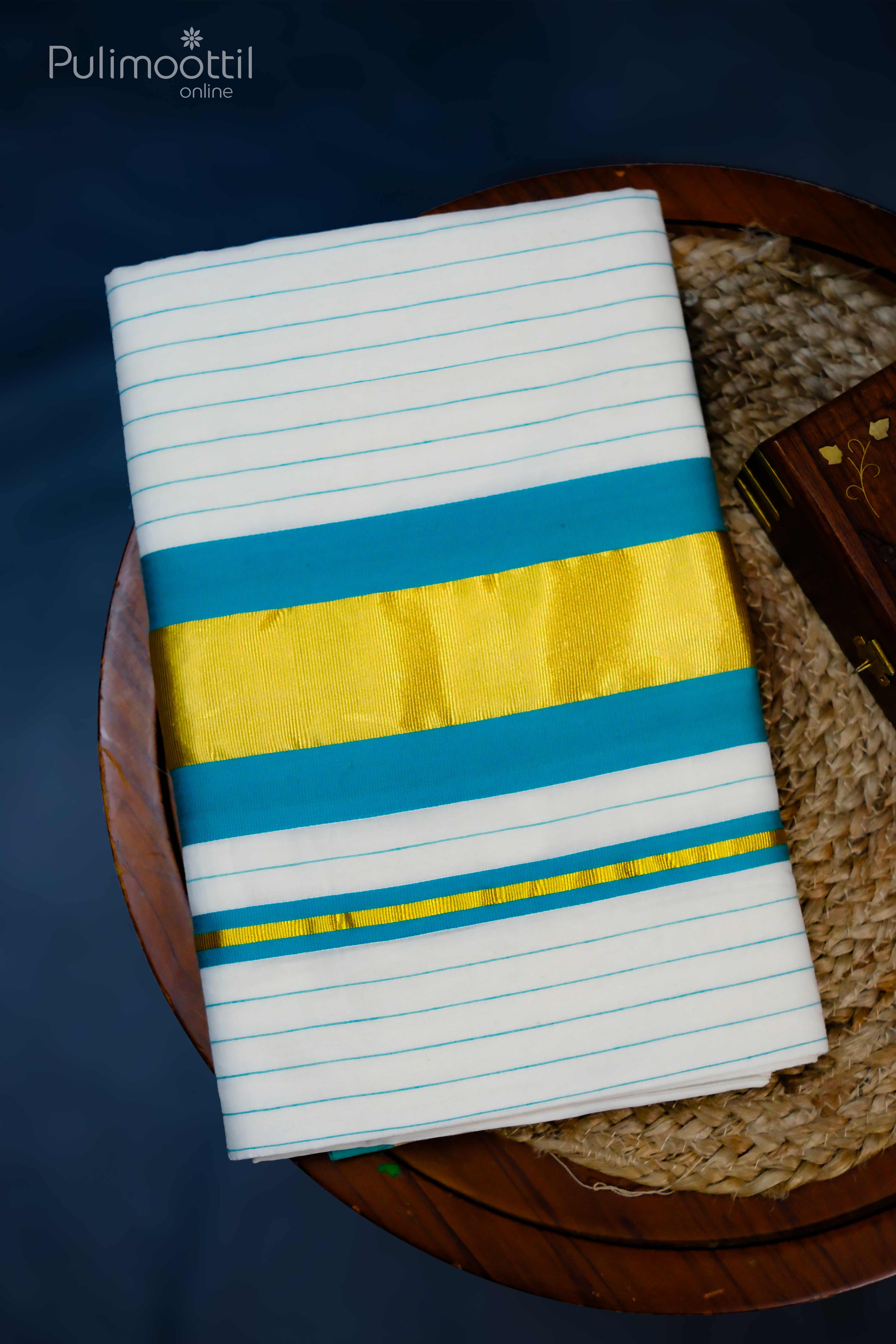 Cream‑white blouse fabric folded, trimmed with soft peach and deep‑blue stripes, draped to showcase its fine cotton texture.