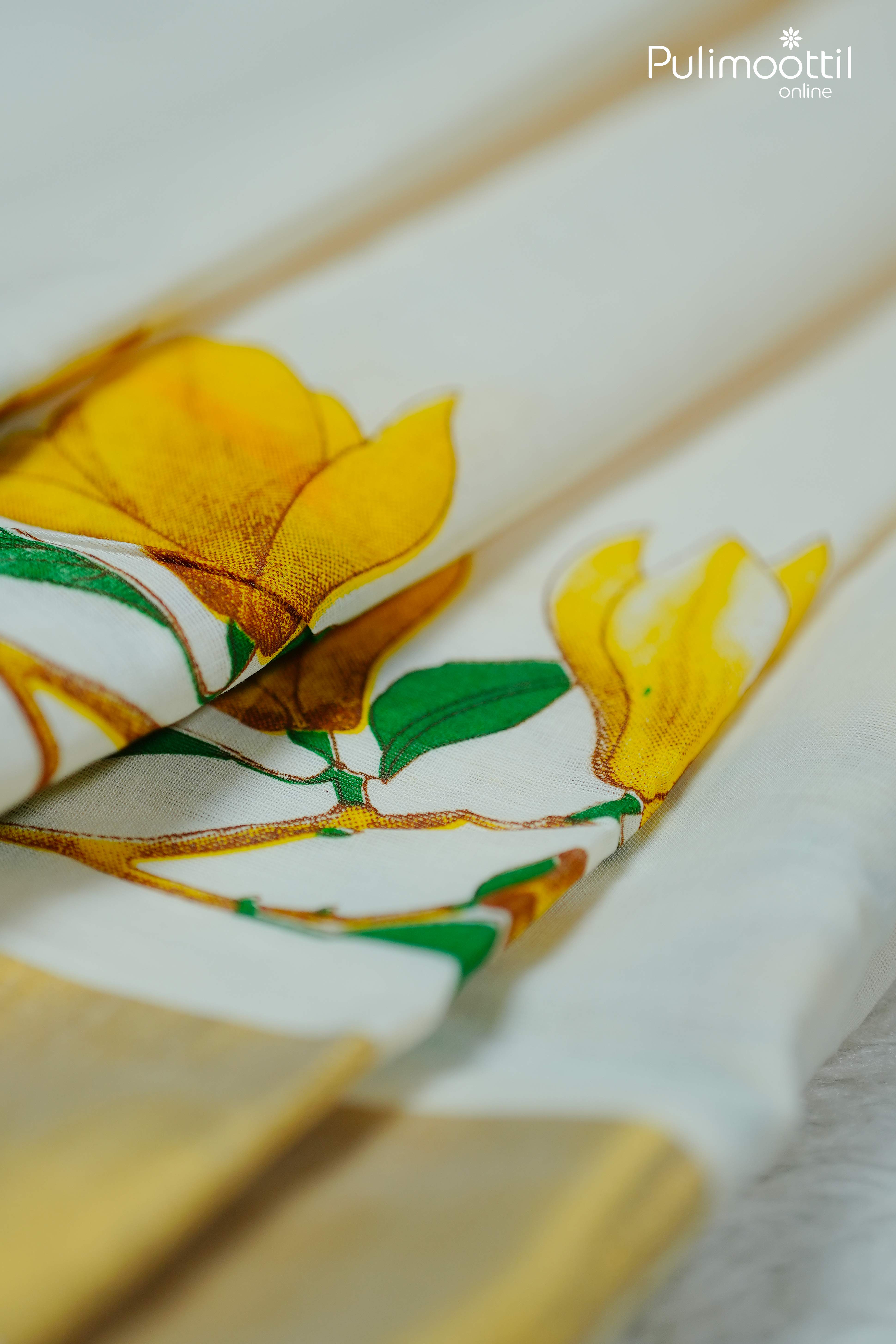 Close-up of pleated Kerala saree with yellow floral print and golden tissue border