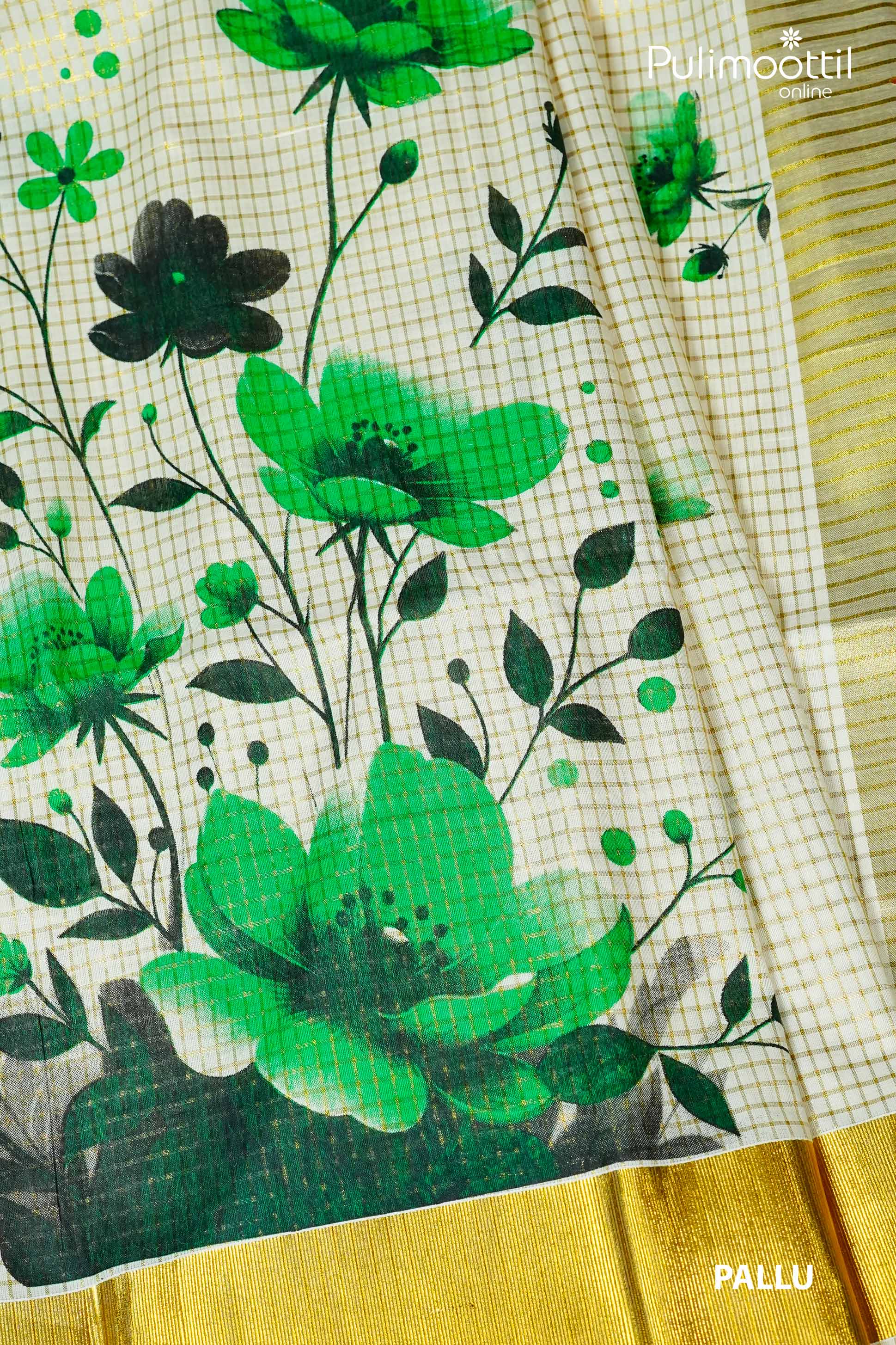 Close-up of Kerala tissue saree pallu with golden zari border, cream base with green and black floral print and fine checkered design.