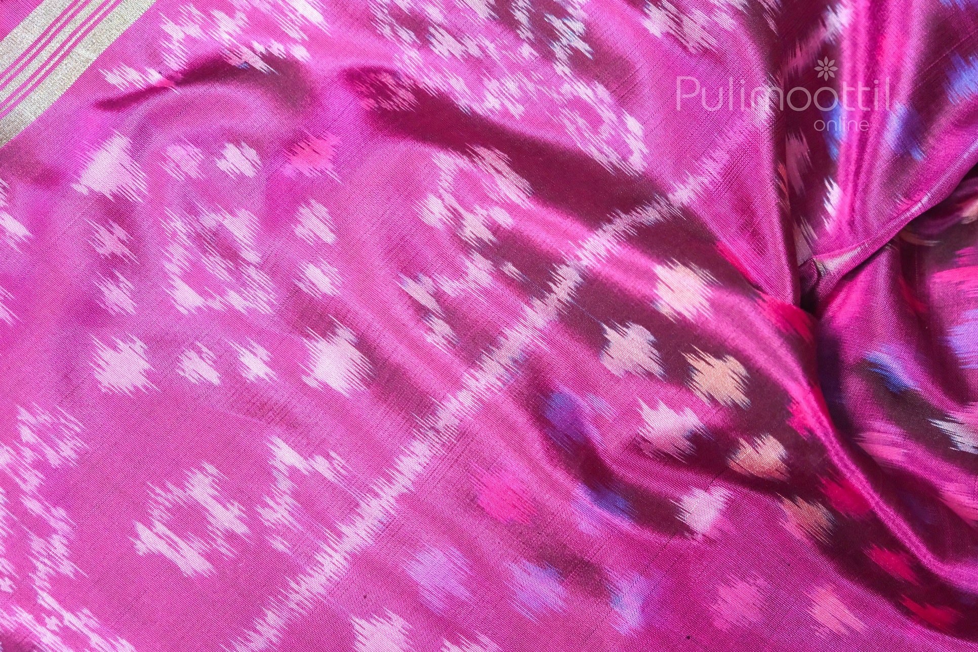 Detailed view of the magenta pure soft silk saree featuring multicolour ikkat patterns and antique zari border, showcasing traditional weaving design.