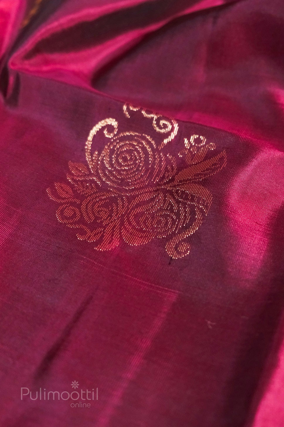 Magenta-pink Kanchipuram soft silk with close-up of gold zari floral motif, highlighting rose pattern on fabric