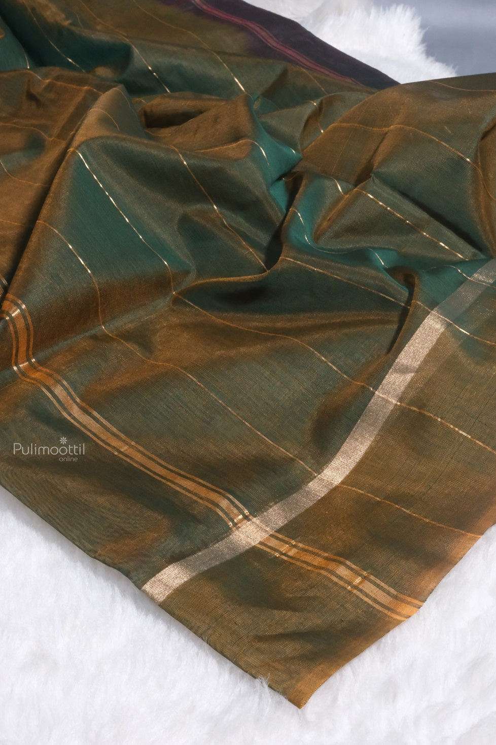 A portion of the saree displaying a grid-like golden zari checkered pattern over green and mustard brown shades, with a shimmering finish and contrasting border.