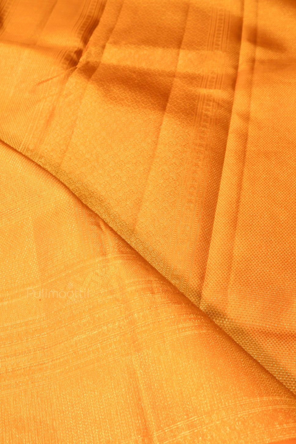 Pure Kanchipuram mustard saree close-up showing fine silk weave and zari detailing