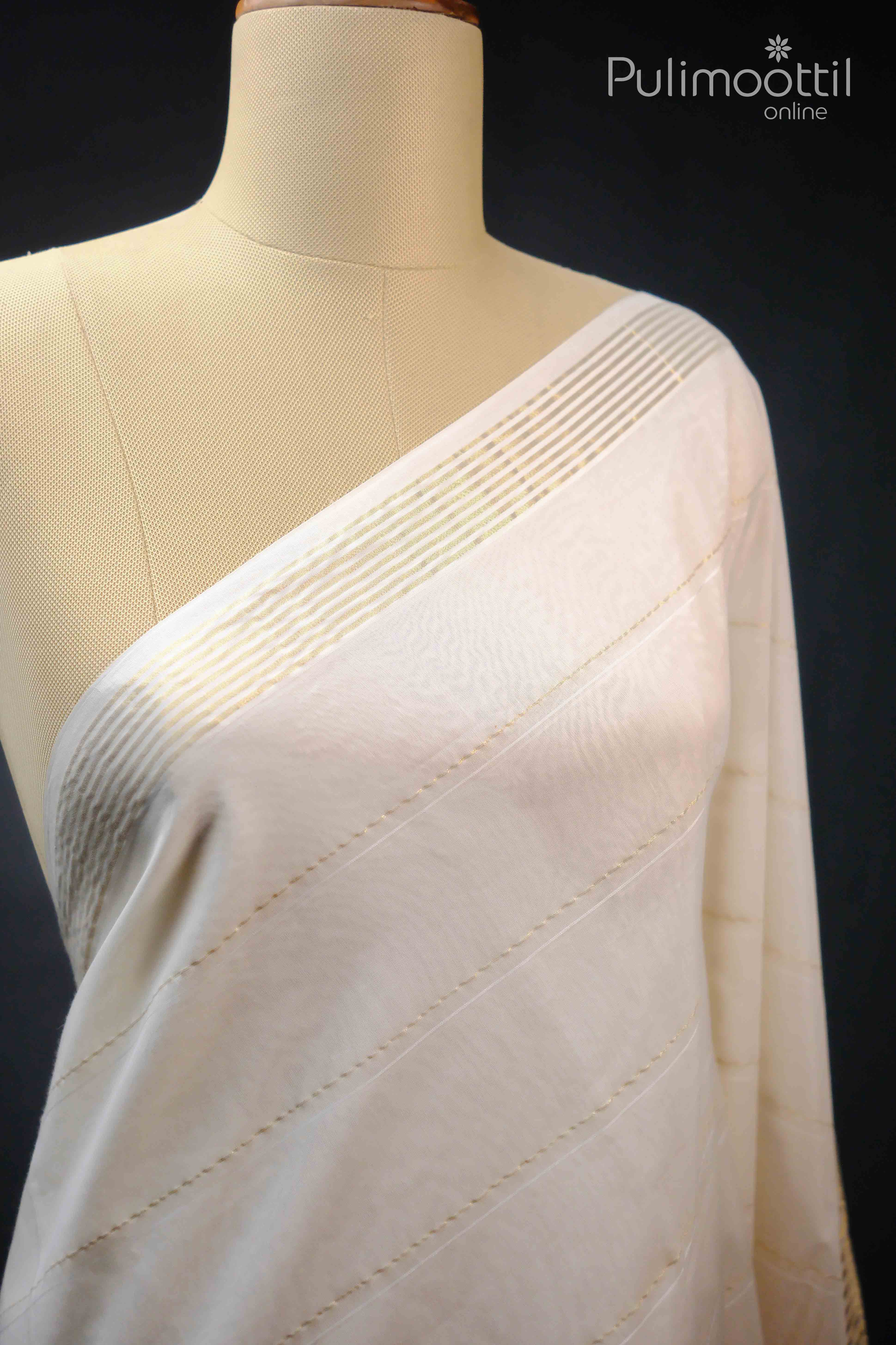 Elegant Kerala kasavu saree with golden zari border draped on a mannequin, ideal for traditional Onam celebrations.