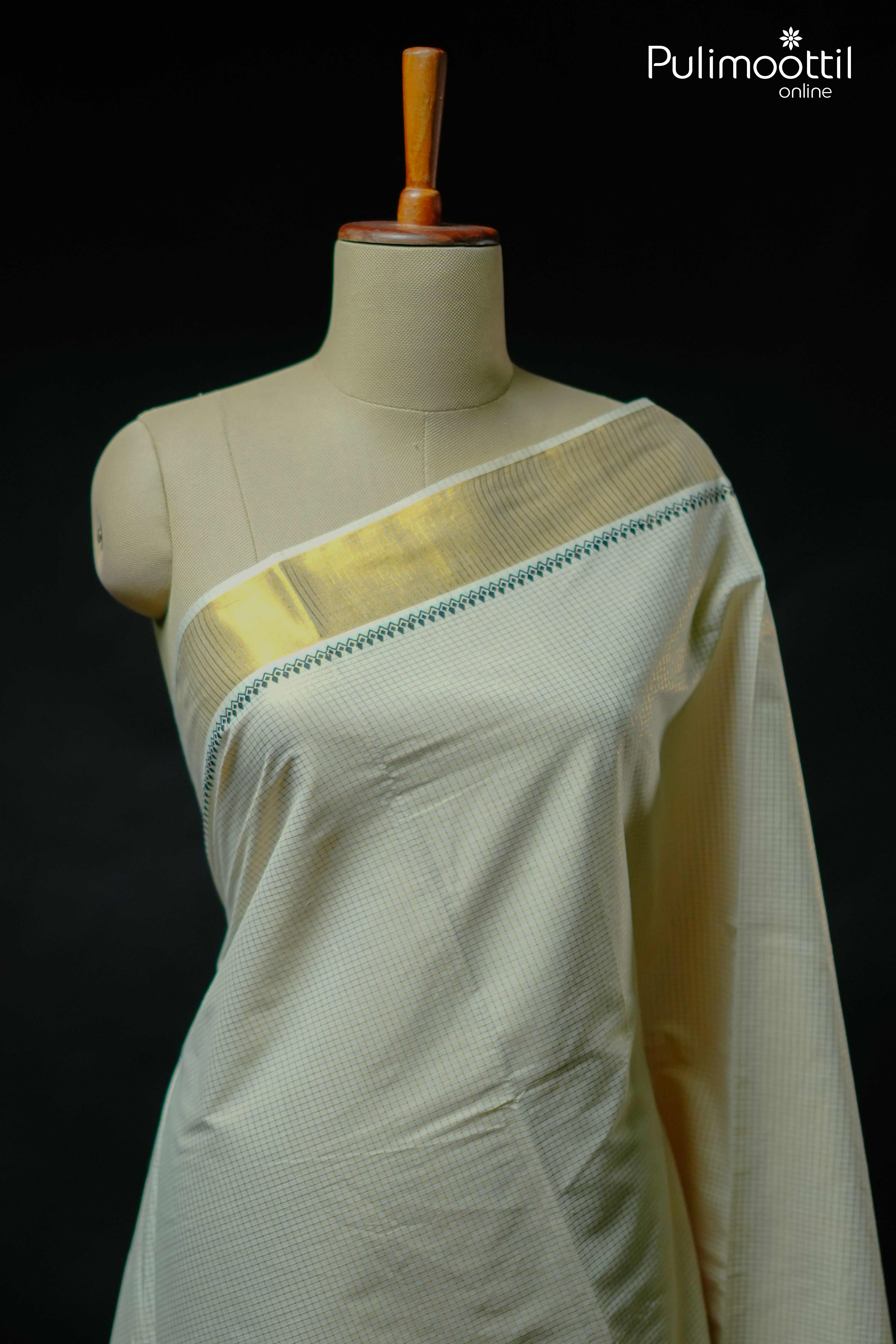 Off white Kerala set saree with golden tissue border and green detailing, golden zari checks, displayed on mannequin