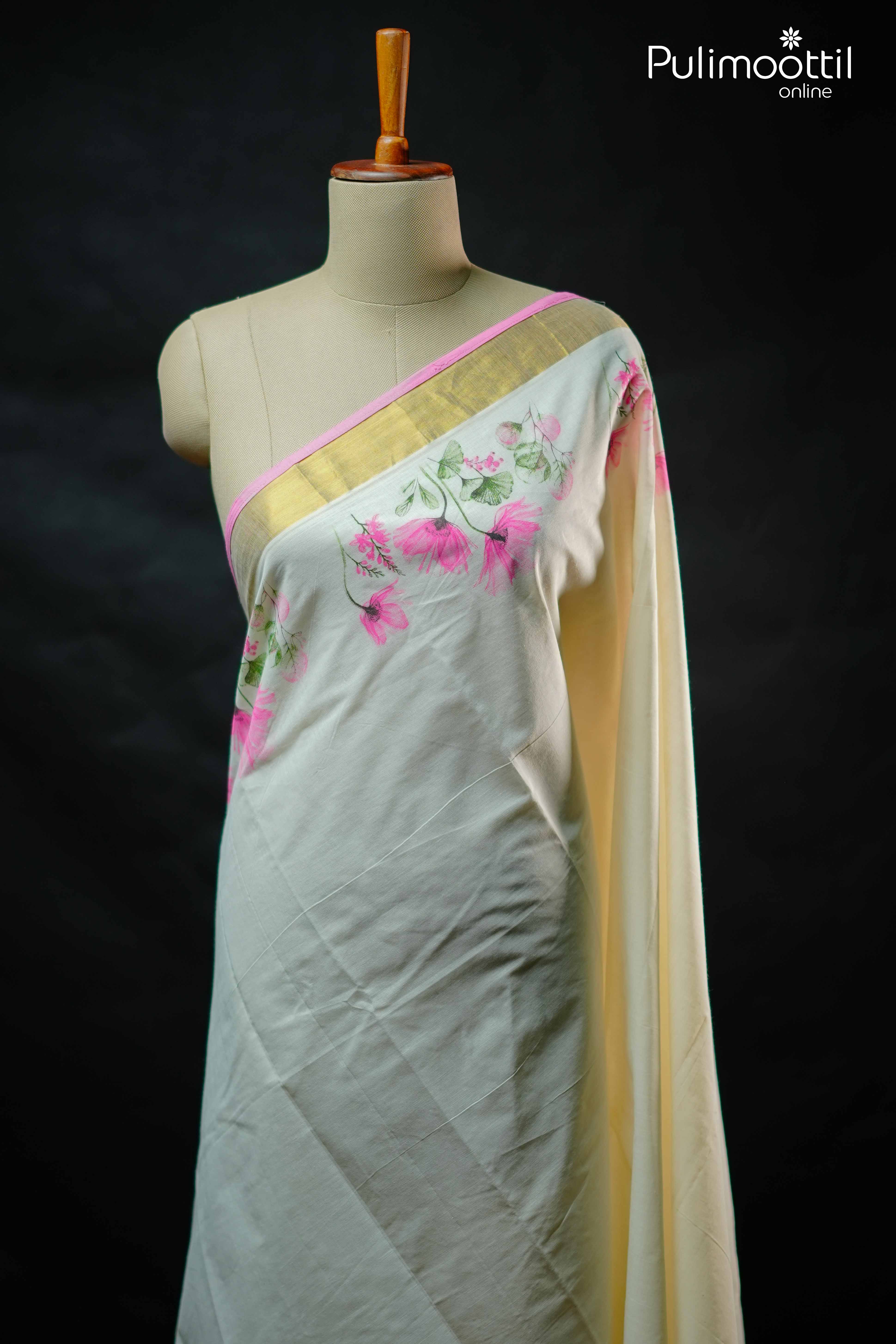 Off white Kerala set saree with pink floral print on body and golden tissue border, draped on mannequin.