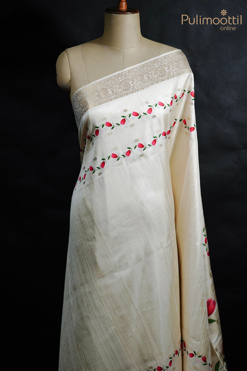 Off white semi tissue silk saree with printed floral motifs on body and antique zari designer border, displayed on mannequin.