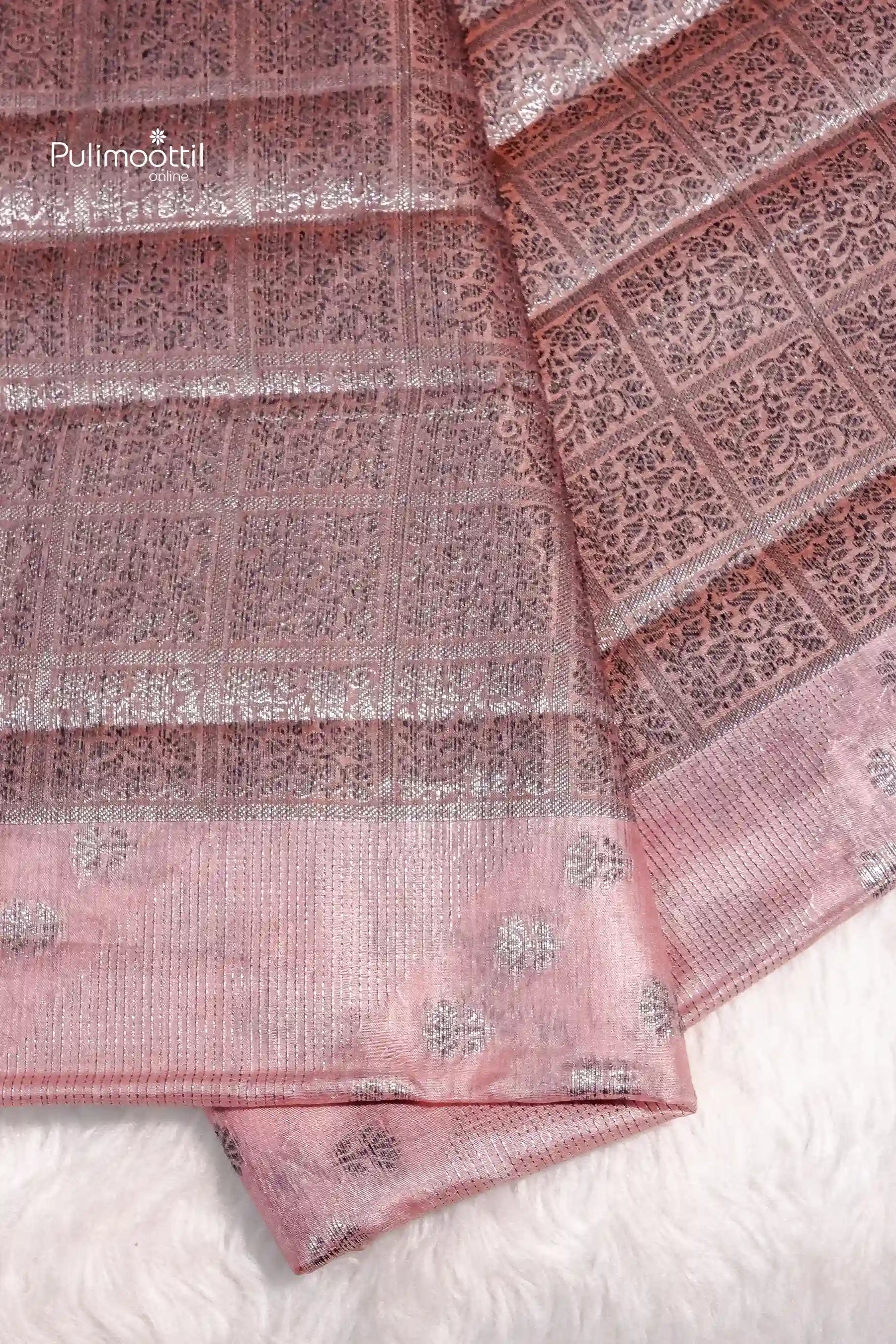 Onion pink pure tussar silk saree with intricate silver zari work and floral butta motifs, displayed on a soft white surface
