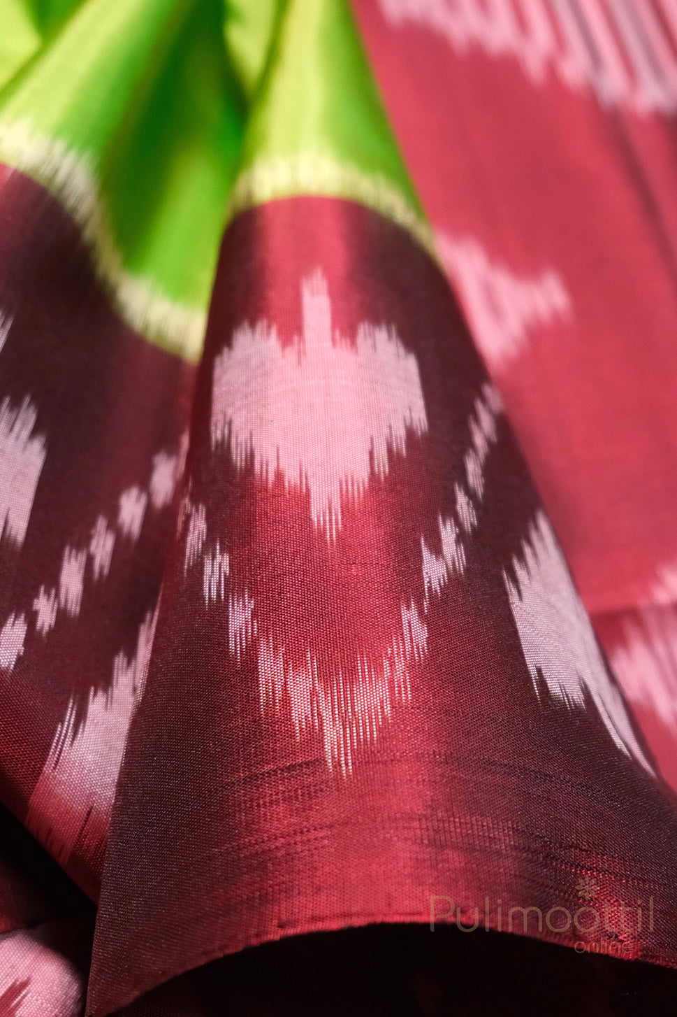 Close-up of maroon soft silk saree with flowing folds and rich luster.