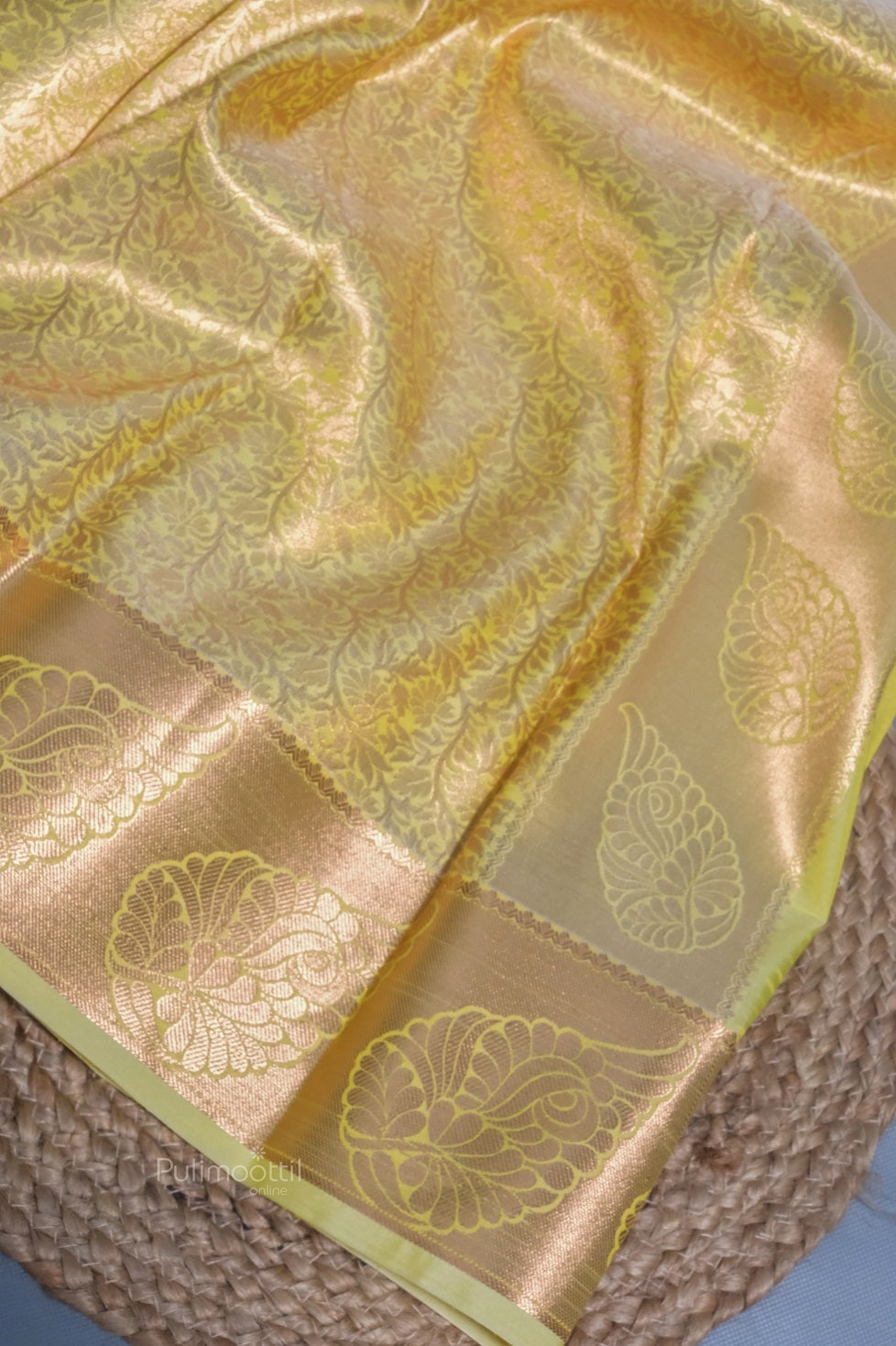 Back view of the saree drape highlighting the rich zari border and flowing silk texture.