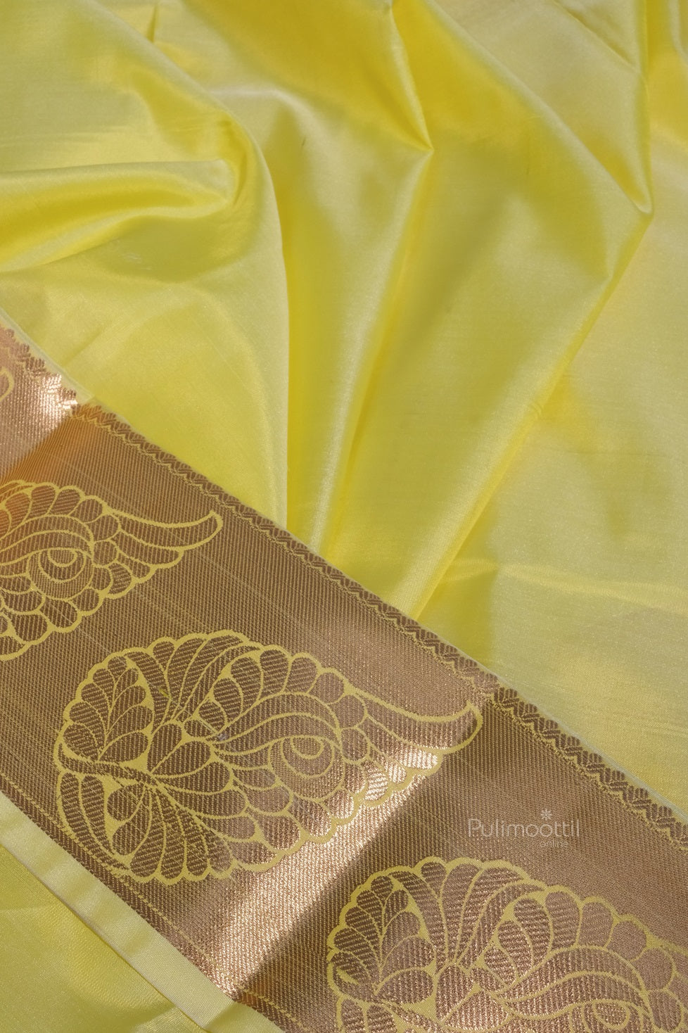 Matching pastel yellow blouse piece with intricate gold zari border, complementing the Kanchipuram bridal saree.