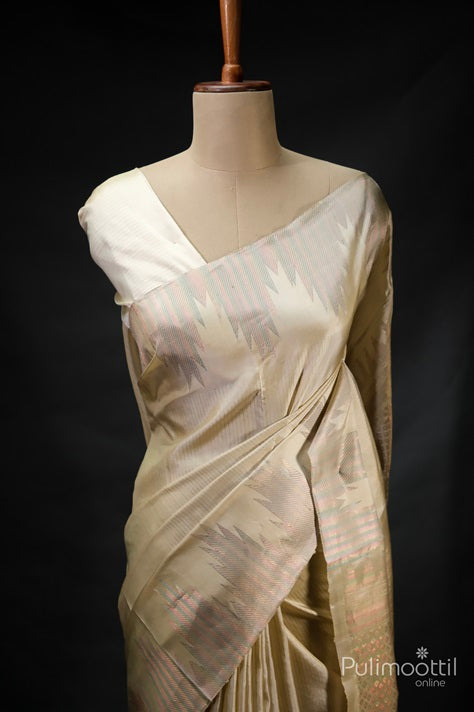 Pastel colour pure soft silk saree draped on mannequin, featuring subtle multicolour zari stripes and traditional temple design border.