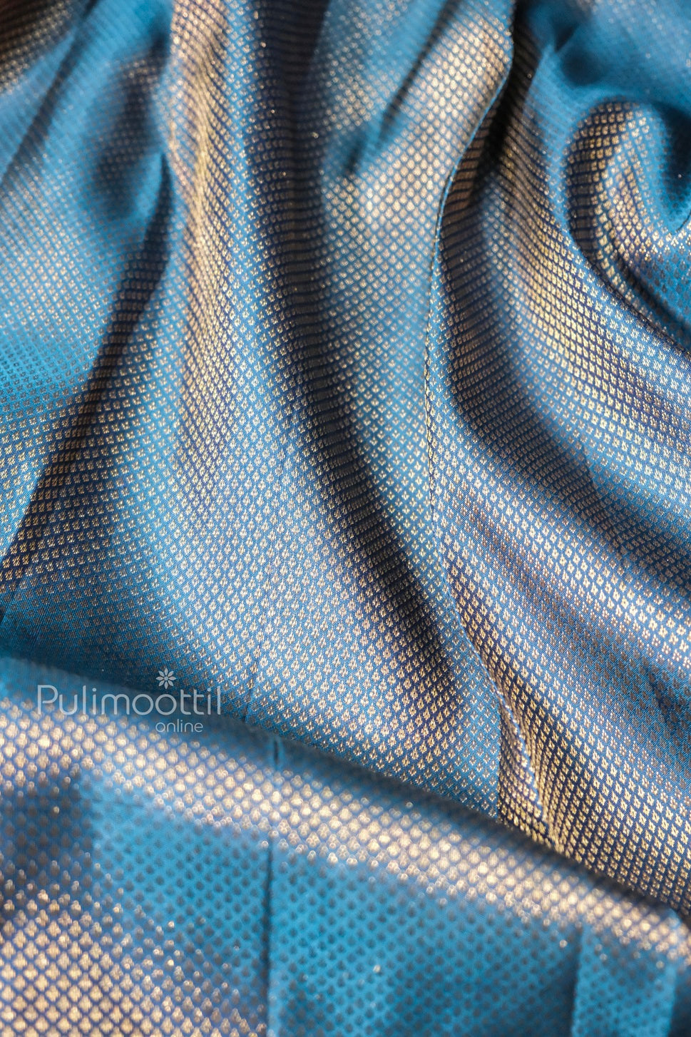 Close-up of blue Banarasi silk saree with intricate golden zari butti weave—luxurious party wear saree ideal for bridal, festive, or wedding occasions.