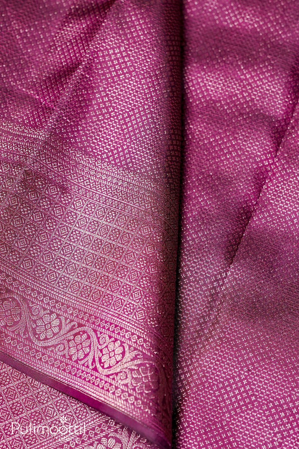 Purple Kanchipuram brocade saree body close-up showing antique gold zari geometric and floral motifs on silk.