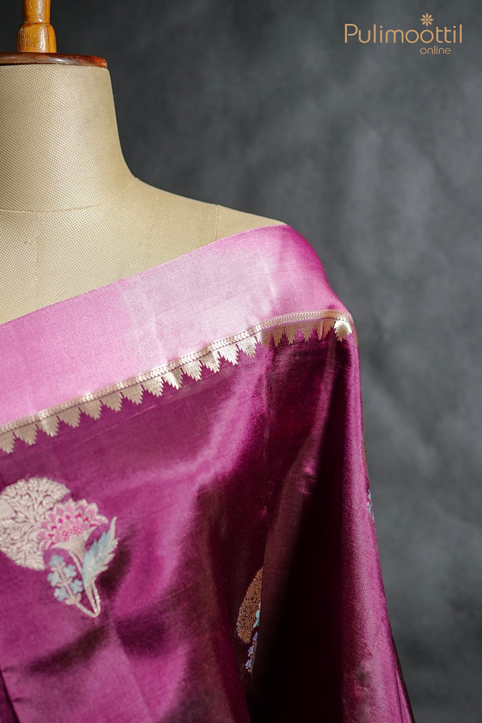 Close-up of purple mango silk saree with golden thread work and satin border draped on mannequin