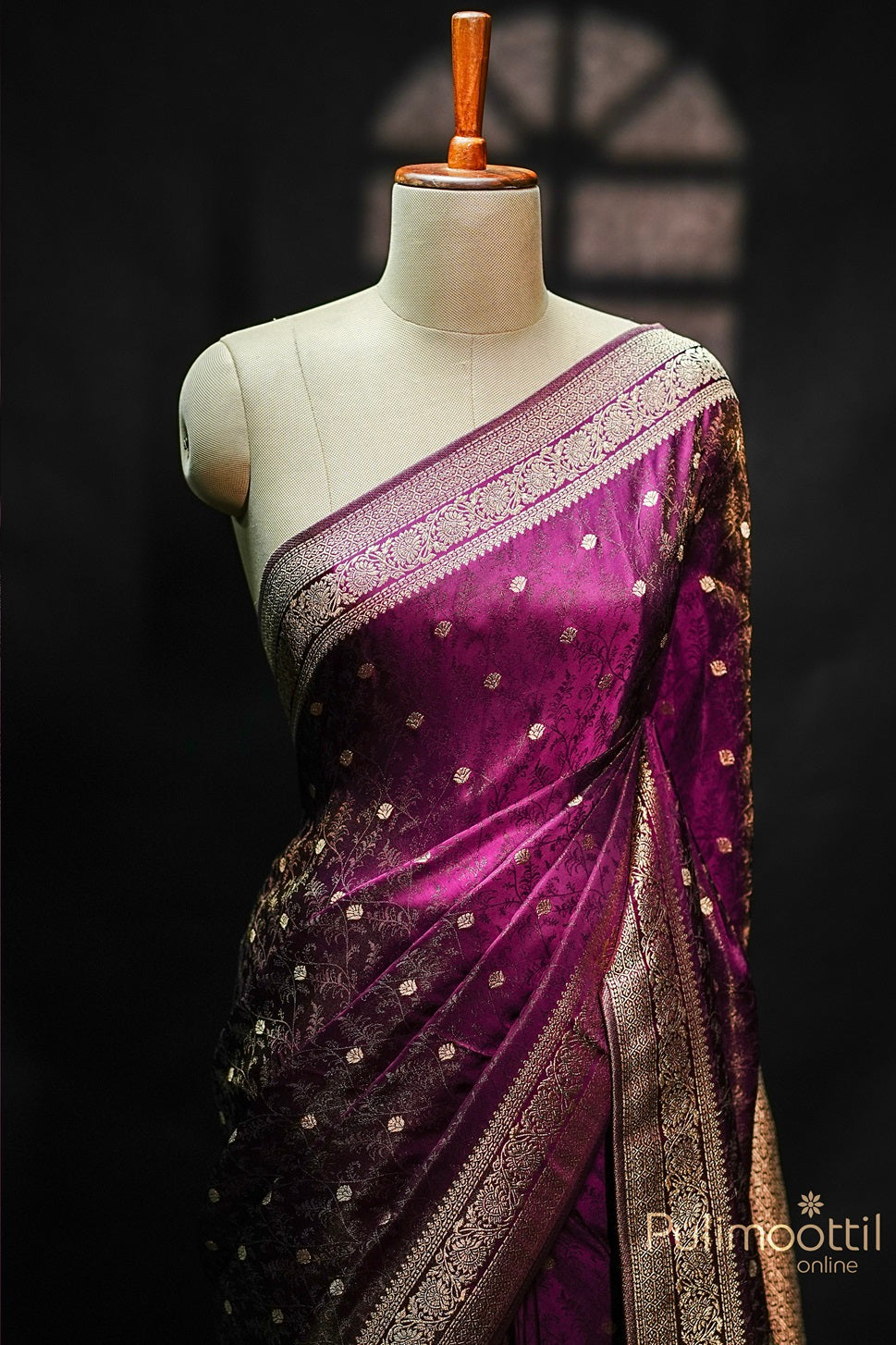 Purple Uppada Banarasi silk saree draped on mannequin, featuring golden floral buttas, copper zari floral self-design, and intricate Banarasi border.

