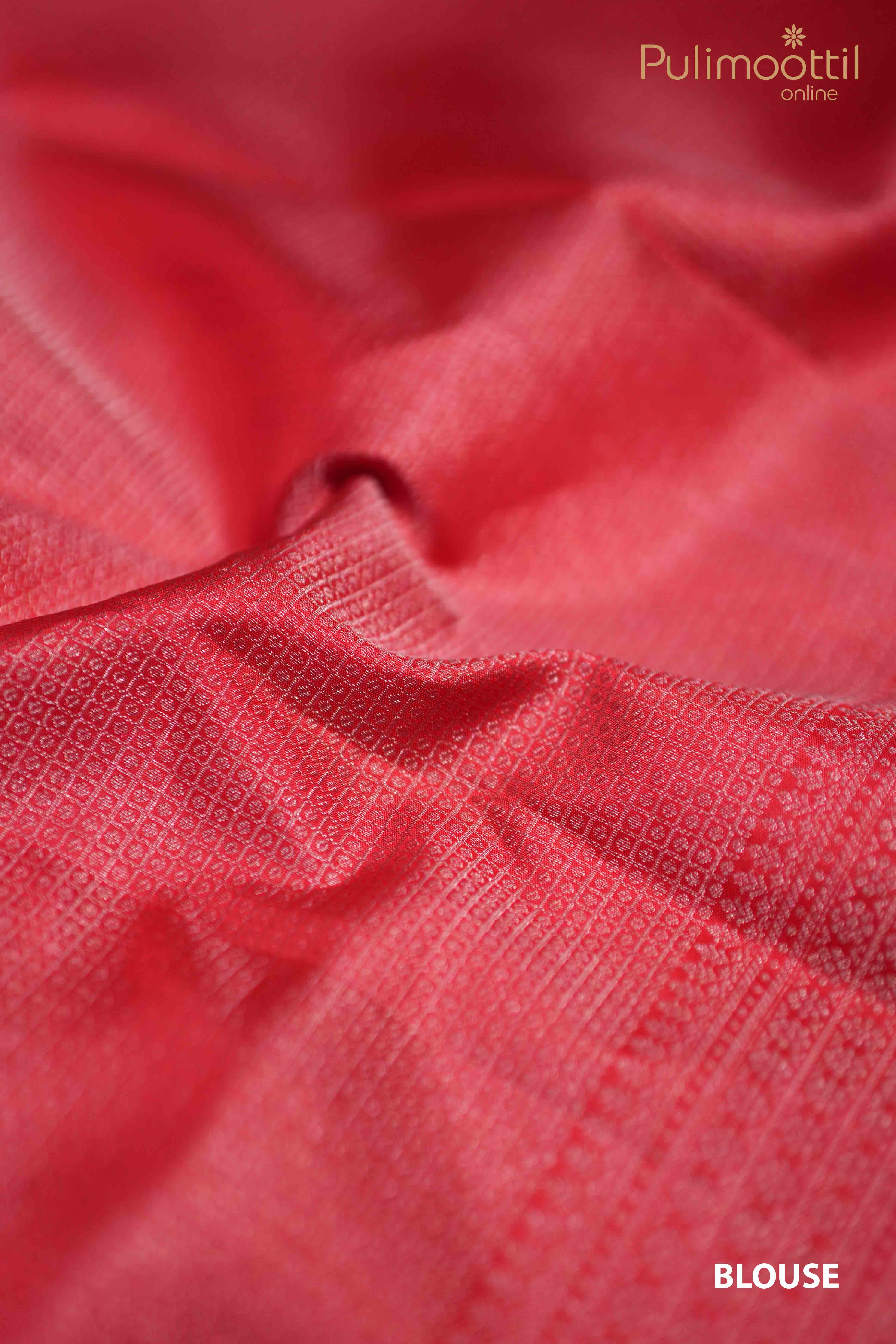 Close-up of Red Kanchipuram blouse fabric with intricate silver zari square brocade design, showcasing the rich texture and fine craftsmanship.