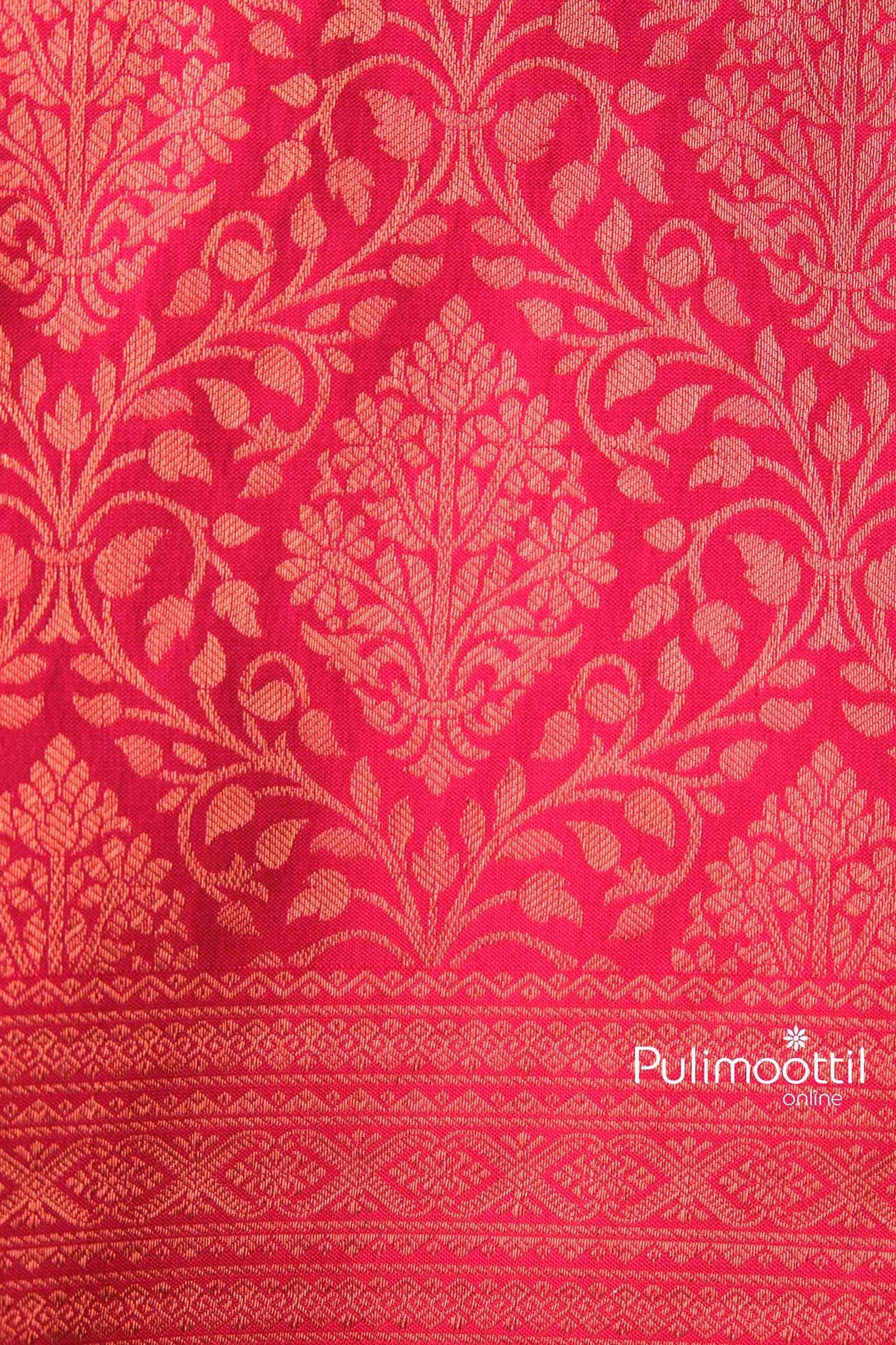 Rich red saree with intricate golden floral motifs and luxurious texture