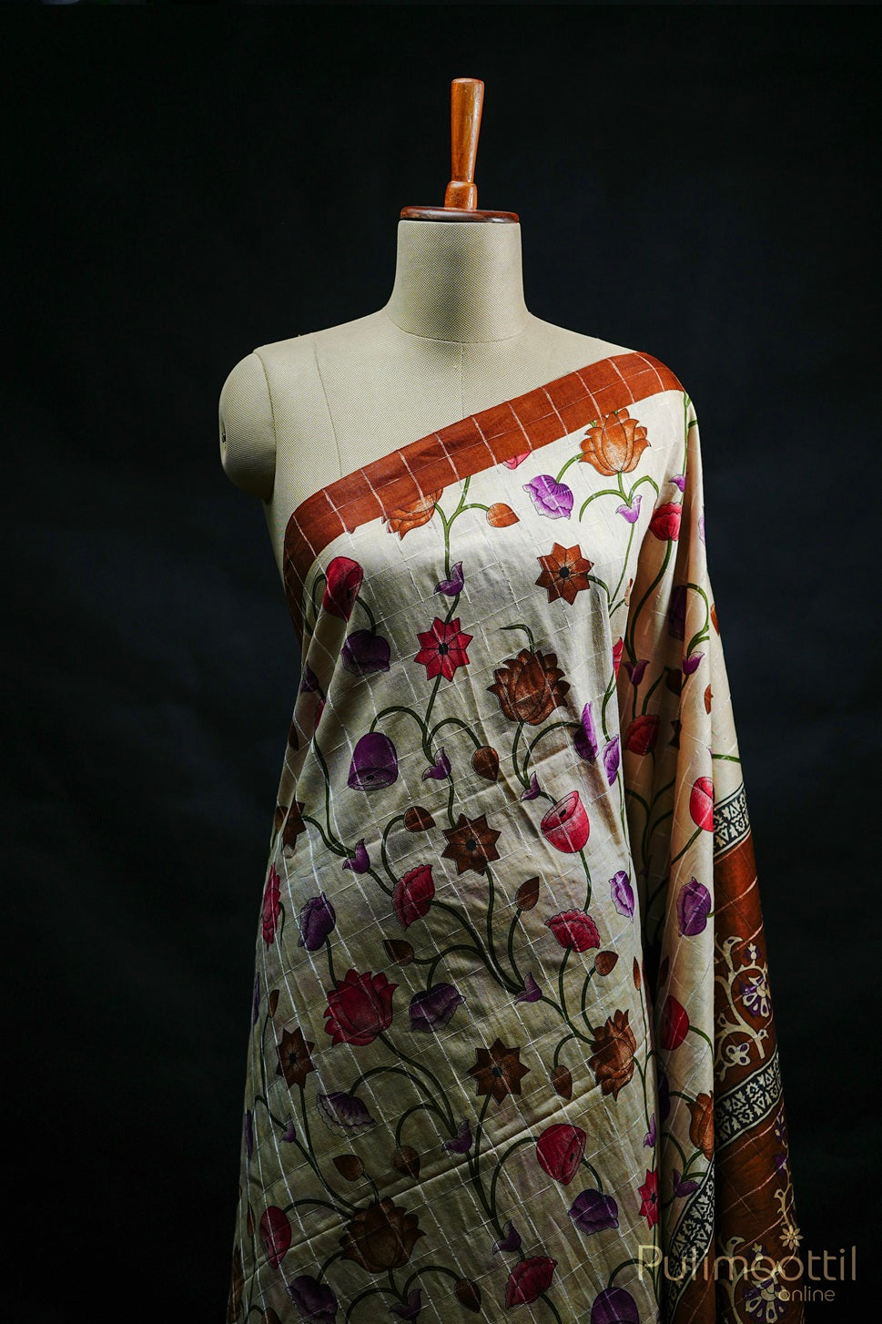 Semi Tussar saree with cream base, multicolor floral print and brown border displayed on mannequin