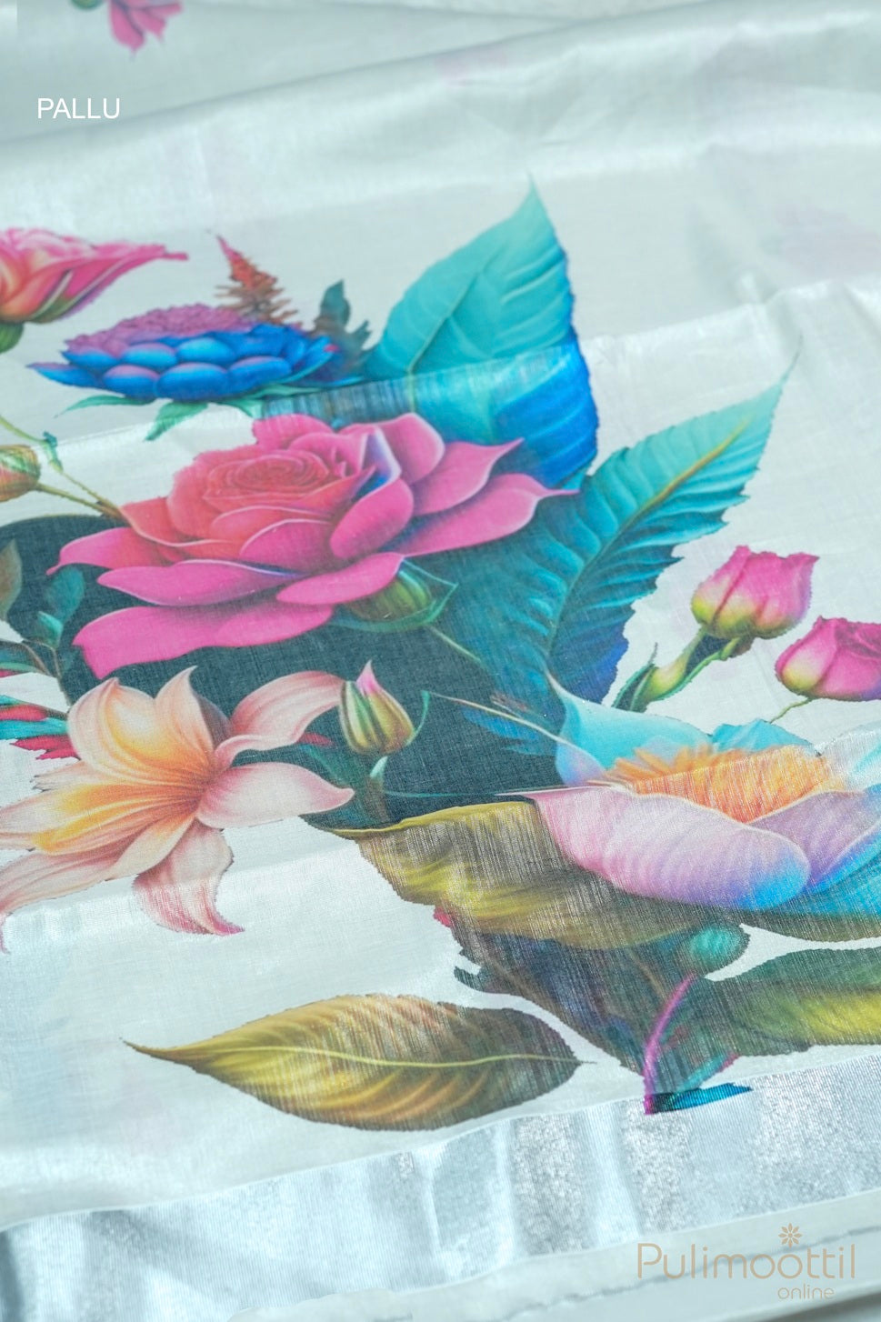 Close-up of pallu on silver tissue Kerala set saree featuring multicolour floral design and silver tissue border
