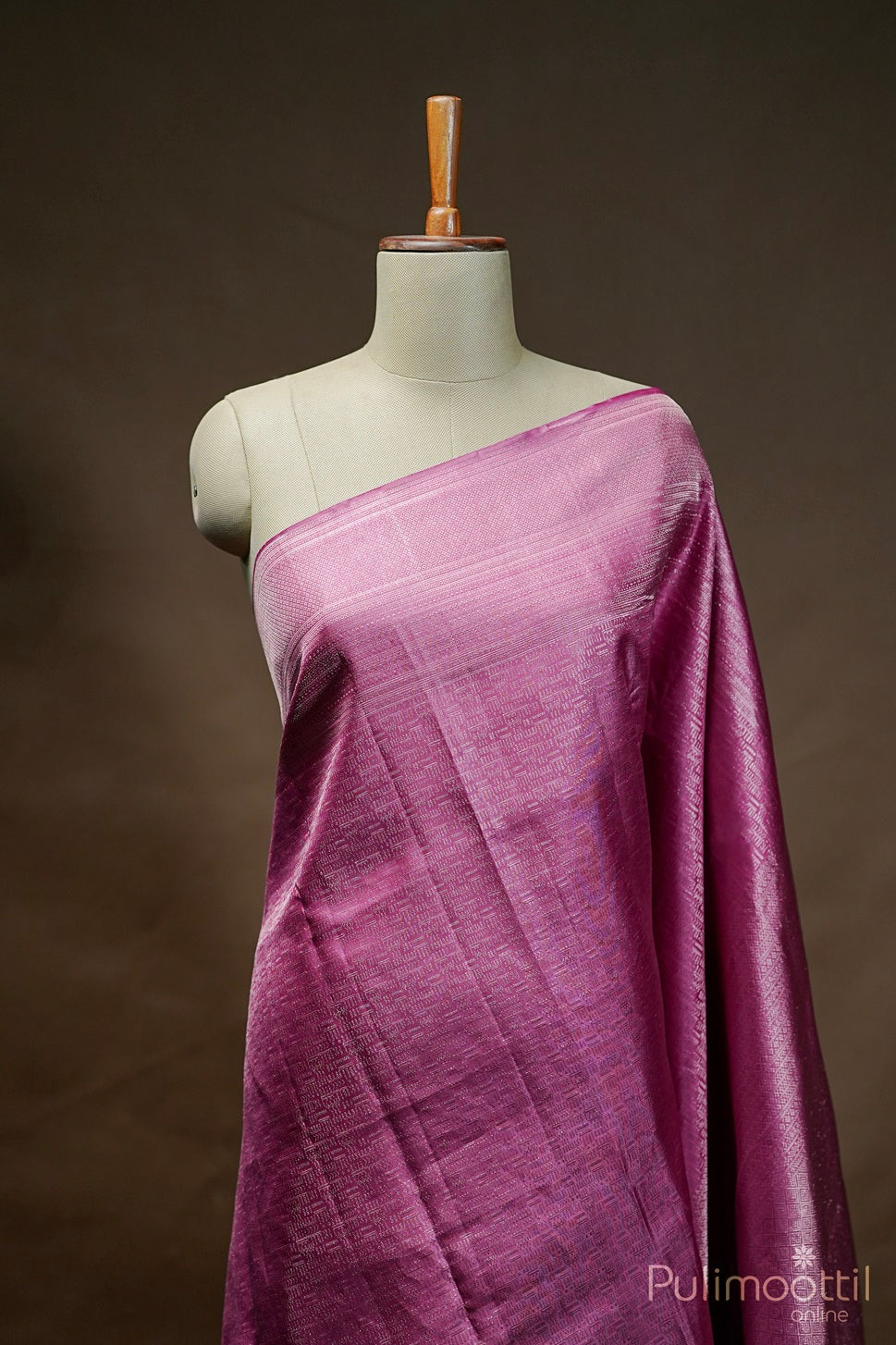 Soft pink Kanchipuram brocade saree with gold zari border and matching blouse drape.