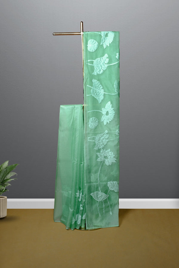 Pastel green color organza saree.