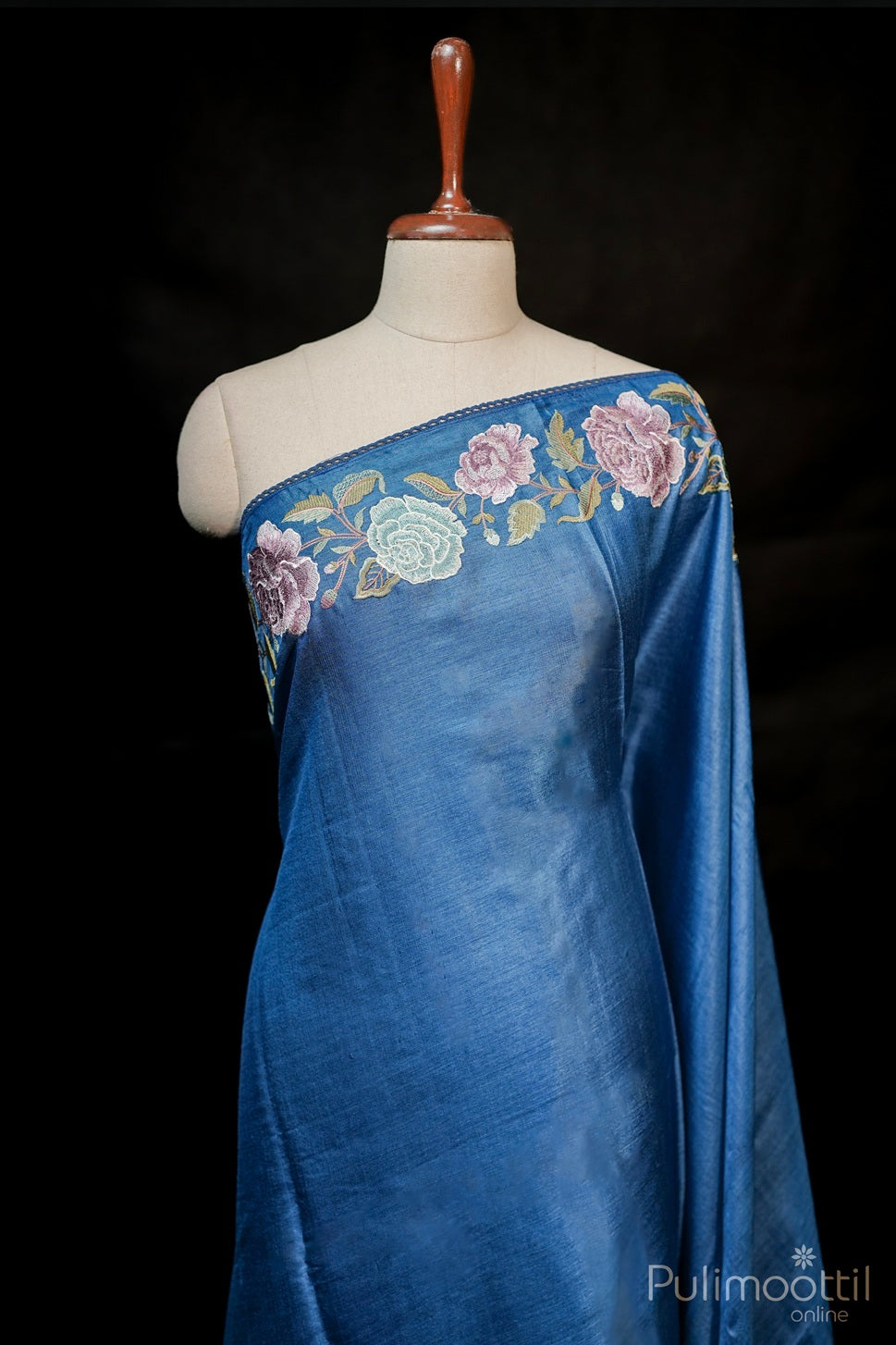 True blue tussar silk saree with plain body and floral threaded border, elegant lace detail, traditional festive wear for women.