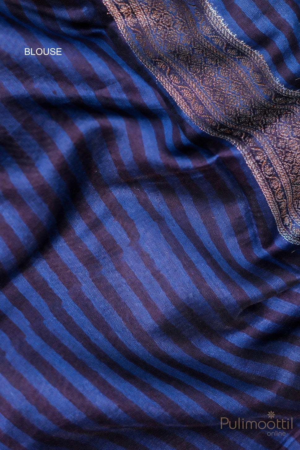 Close-up view of the turquoise blue Chiniya Banarasi saree fabric, highlighting the striking silver zari square design and the contrast small border, perfect for festive and bridal occasions.