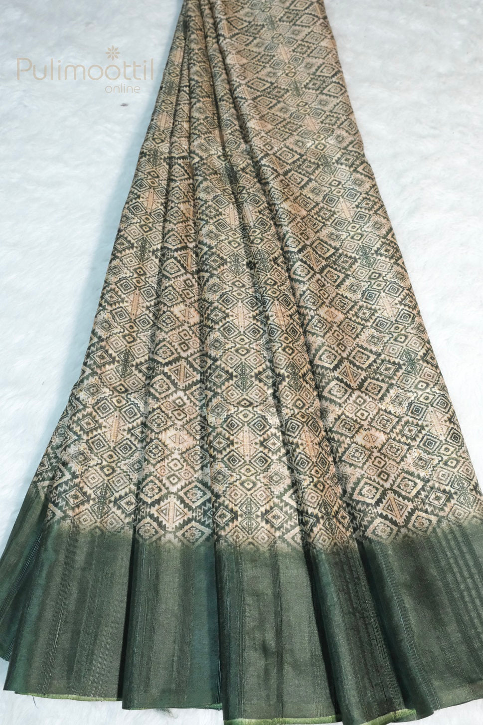 Elegant green soft silk saree with intricate beige geometric motifs and solid green border, neatly draped on white background with Pulimoottil Online branding.