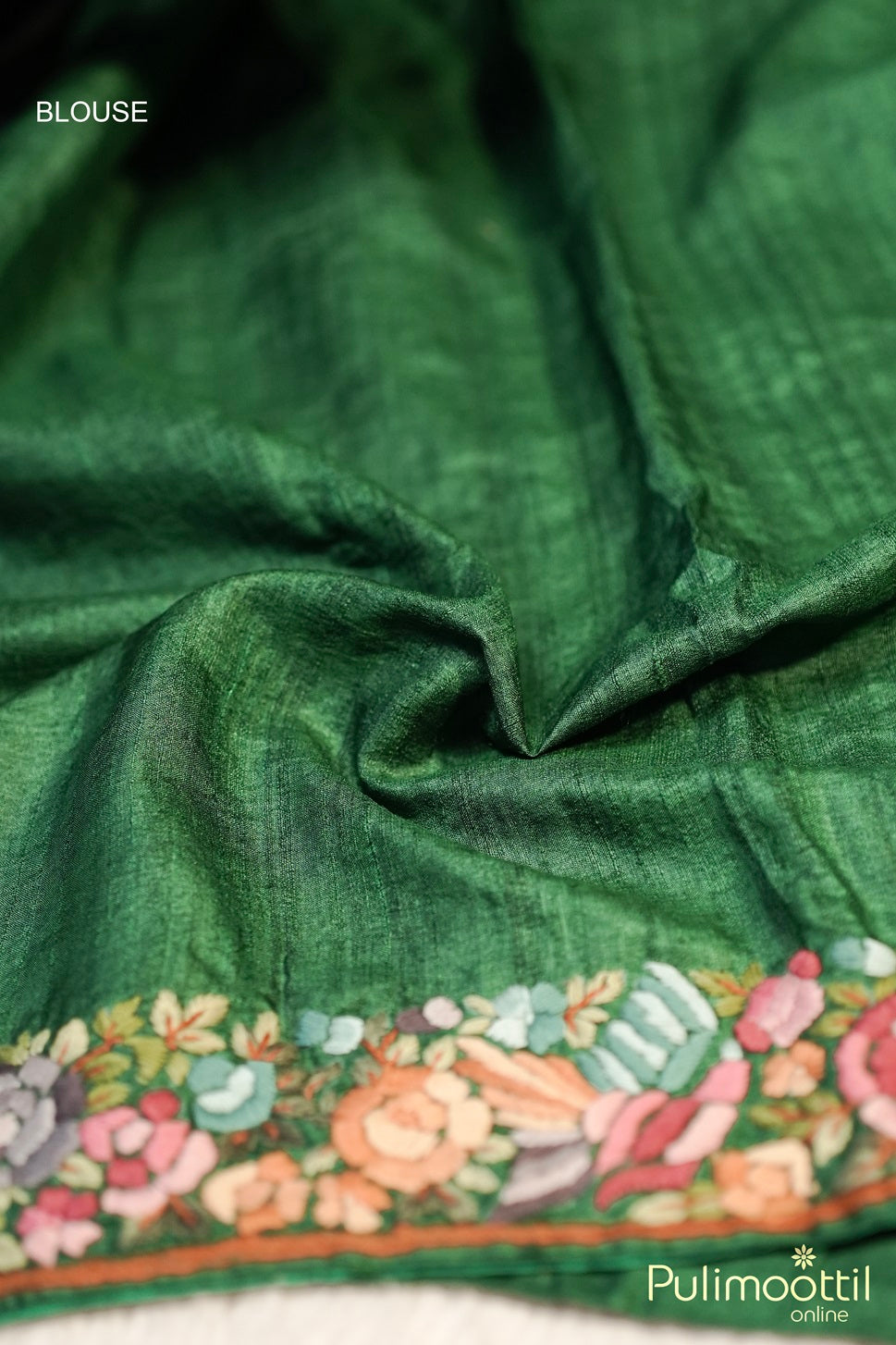 Bottle green jute silk blouse fabric with colorful hand embroidery on sleeve end.
