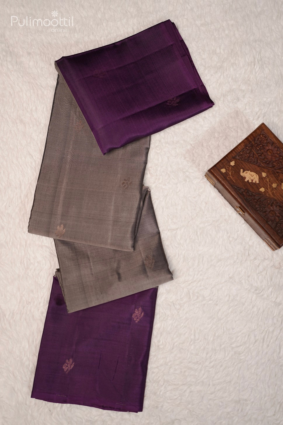 Grey and purple Kanchipuram silk saree with golden buttas and contrast border, displayed on a white textured background.