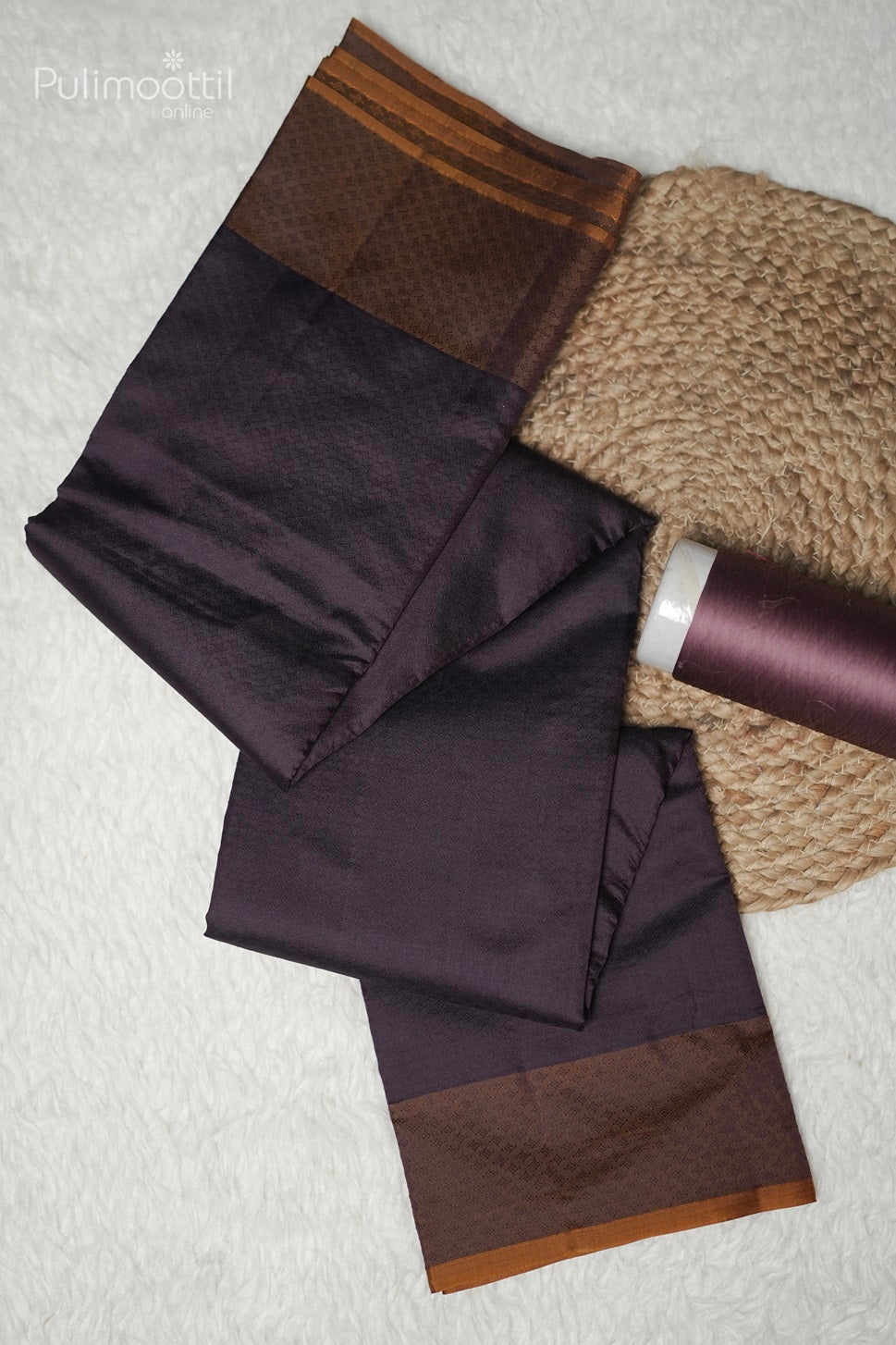 Close-up of self print design on purple Kanchipuram saree with golden yellow border