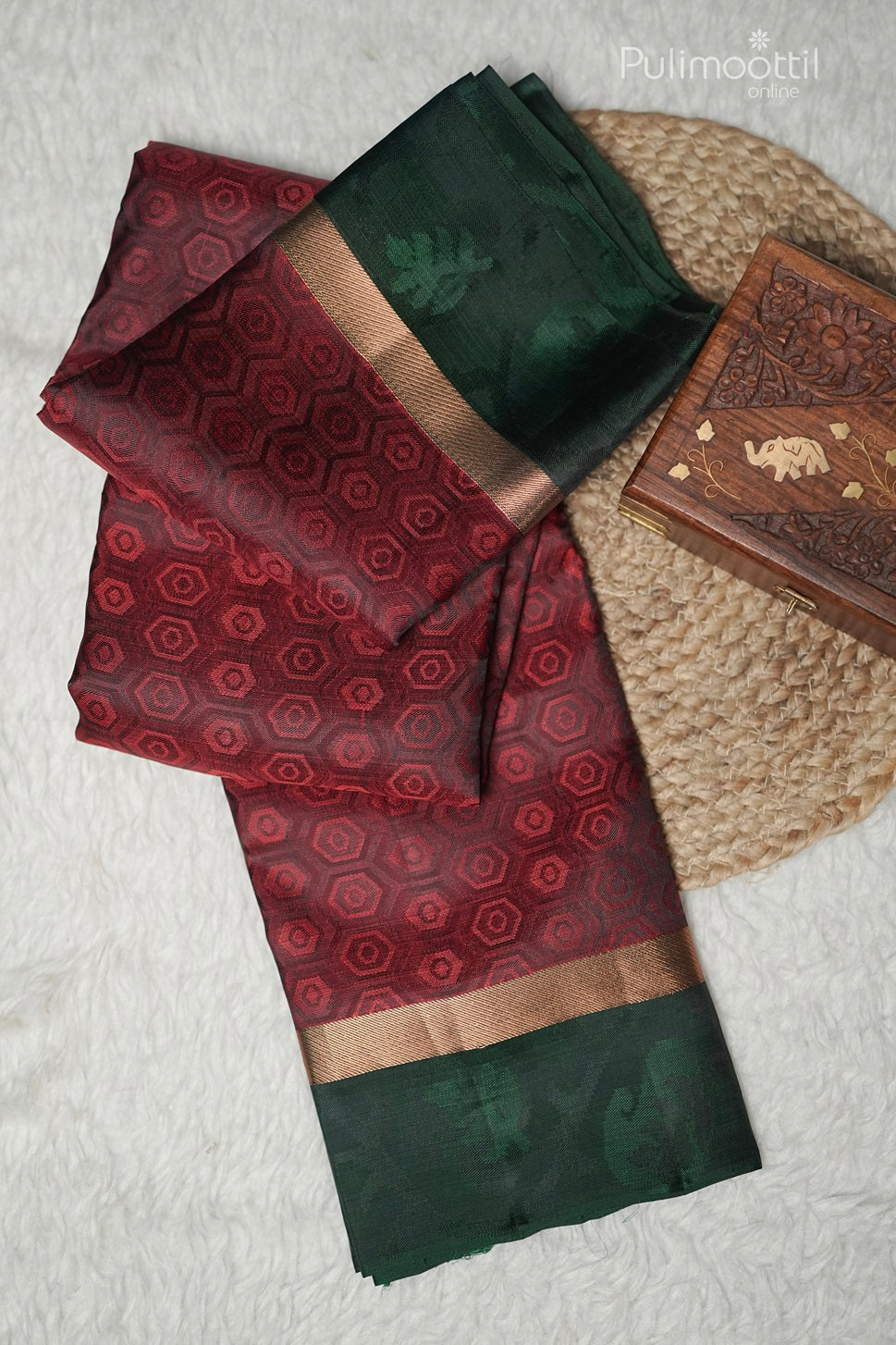 Close-up of maroon pentagon weave and green double border on Kanchipuram silk saree