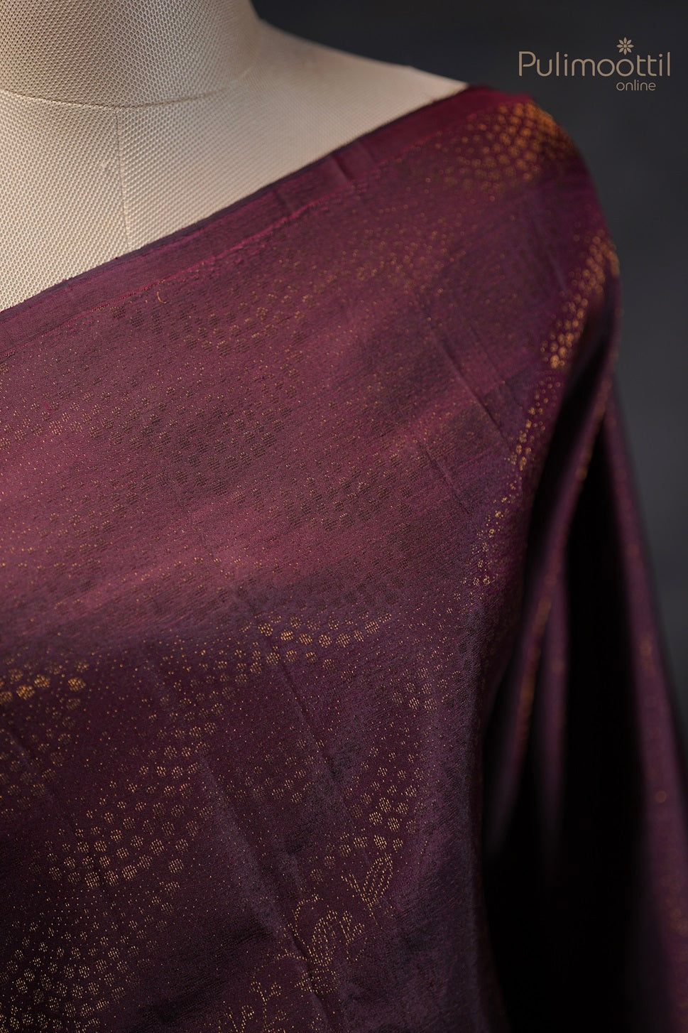  Close-up view of the saree draped on a mannequin, focusing on the intricate designer body pattern without a border.