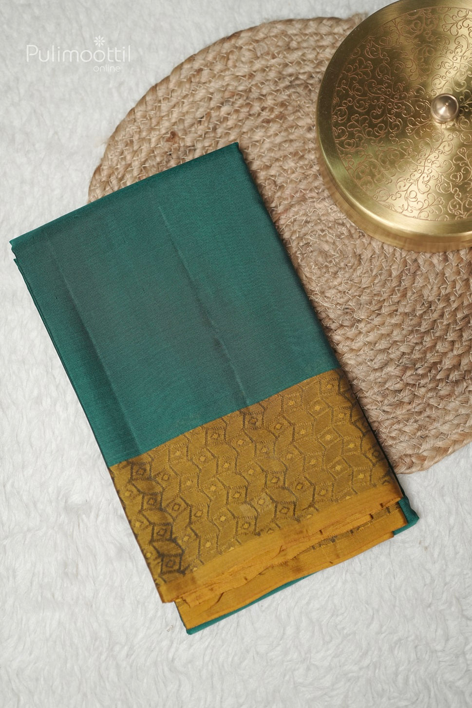 Folded peacock green Kanchipuram saree with golden self print border