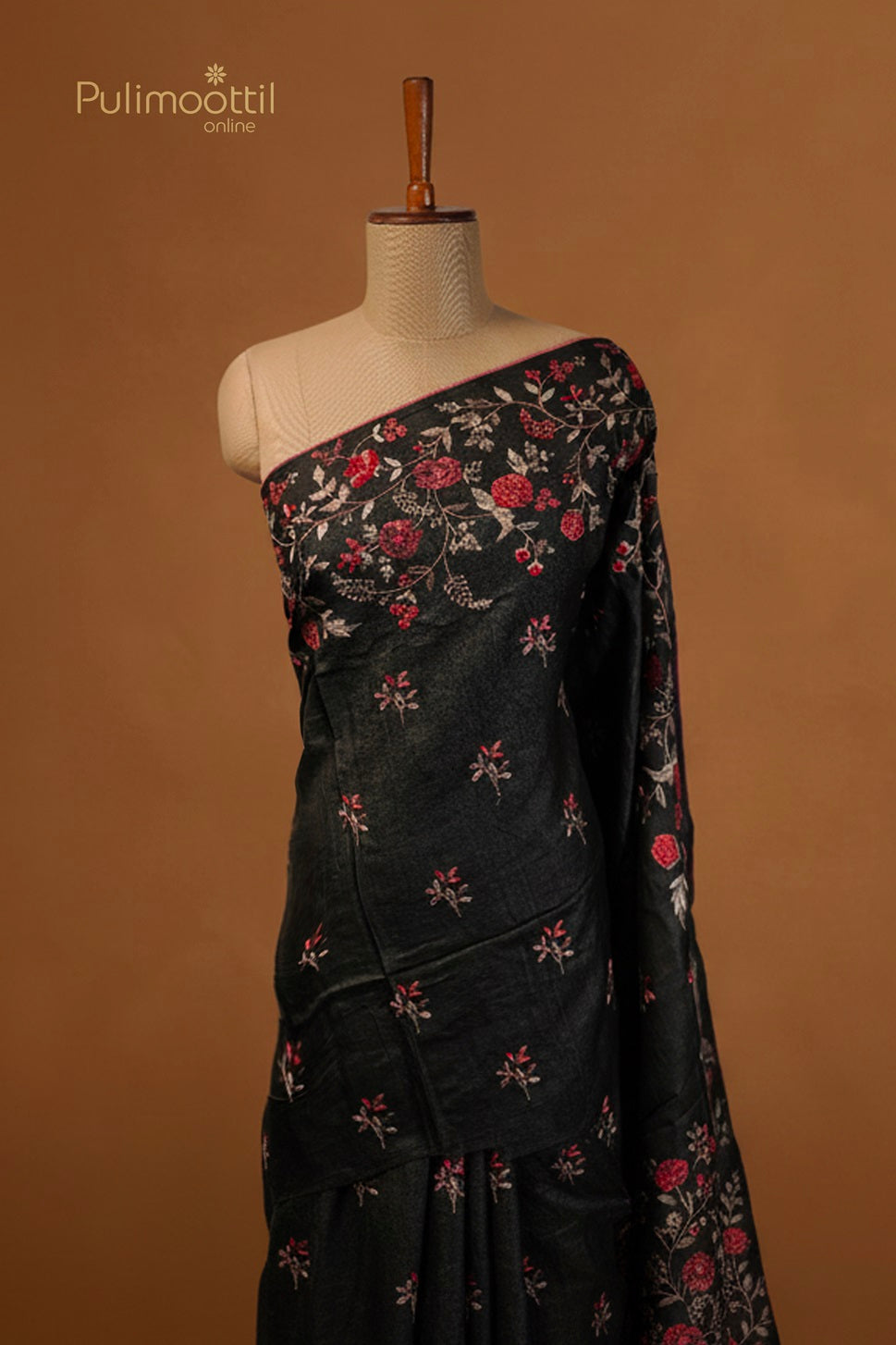 Black saree with red and white floral embroidery on the body and pallu, featuring a contrasting embroidered border.