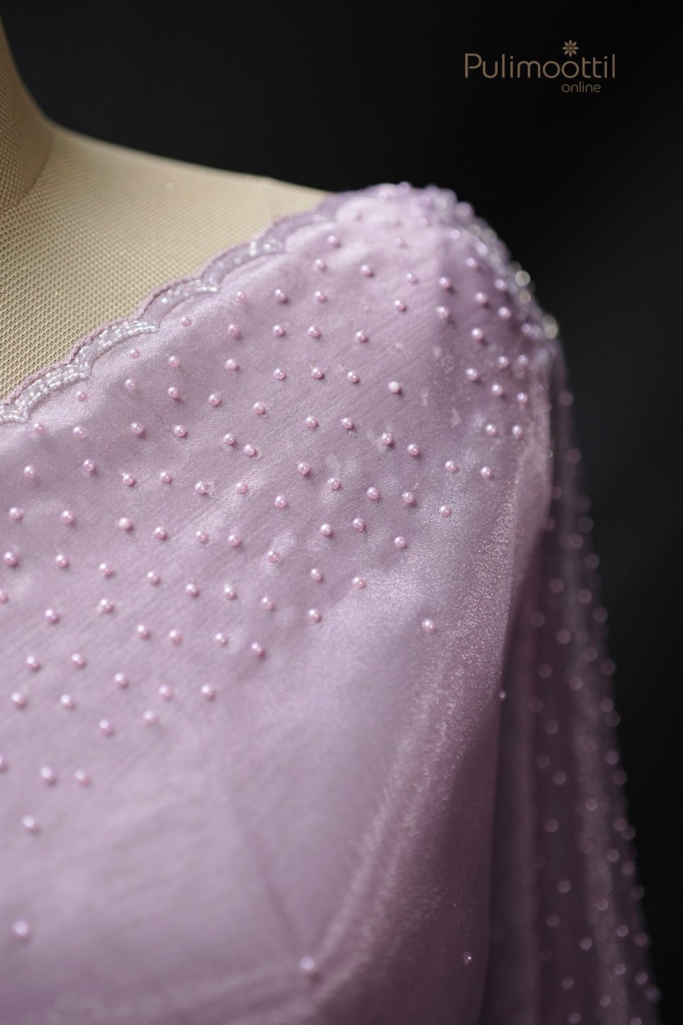 Pallu of the lavender organza saree, adorned with beadwork and floral embroidery along the scallop border.