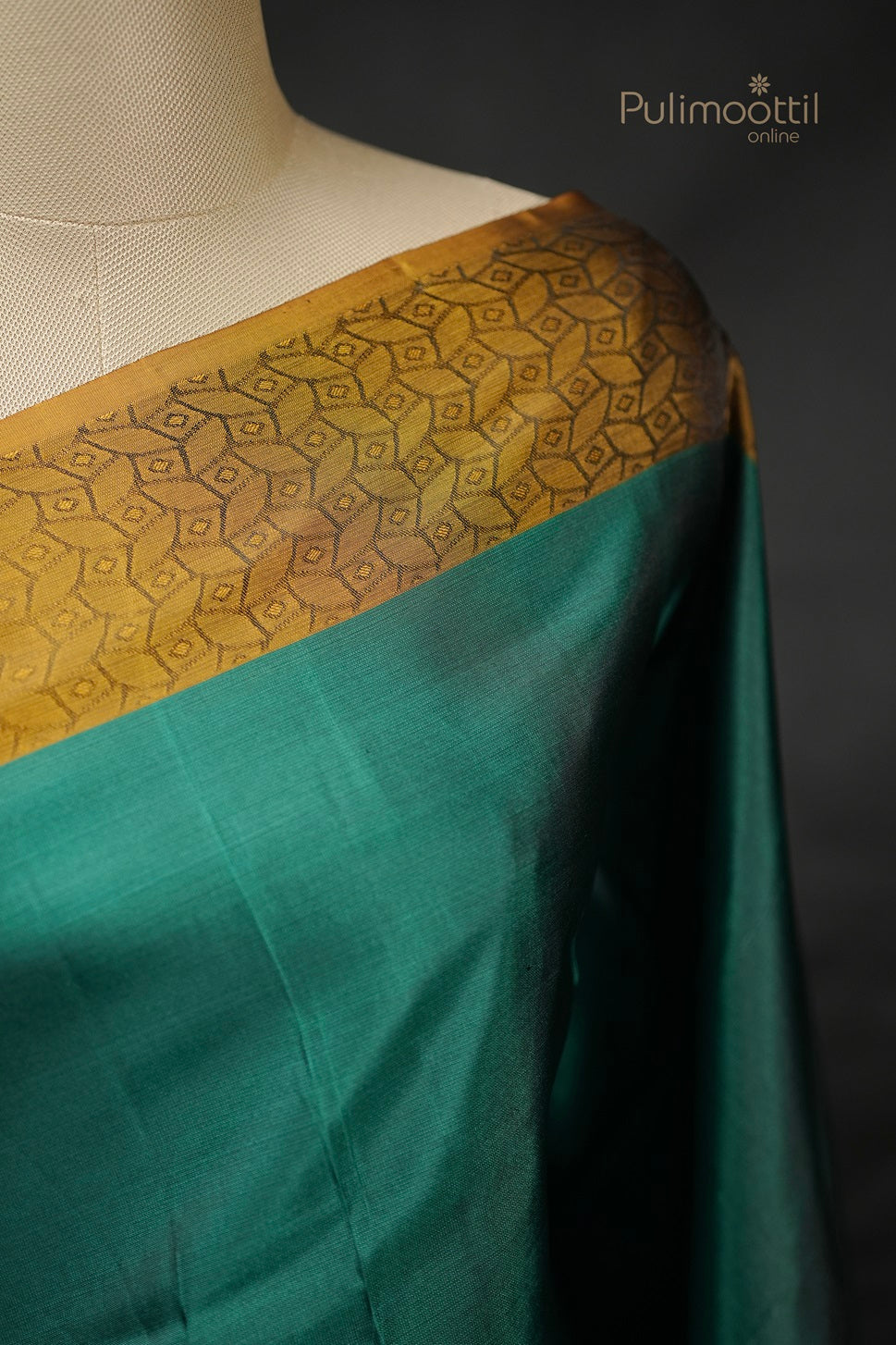Peacock green Kanchipuram saree and blouse with golden self print border, flat lay

