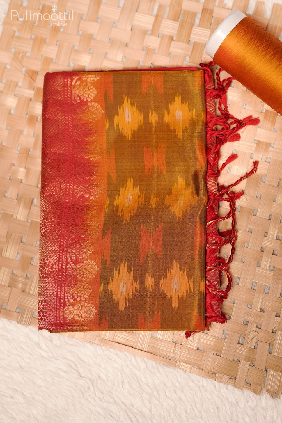 Folded Golden Yellow Ekath Print Kanchipuram Soft Silk Saree with All-Over Print, Contrast Body, and Elaborate Zari Border at the Edge.
