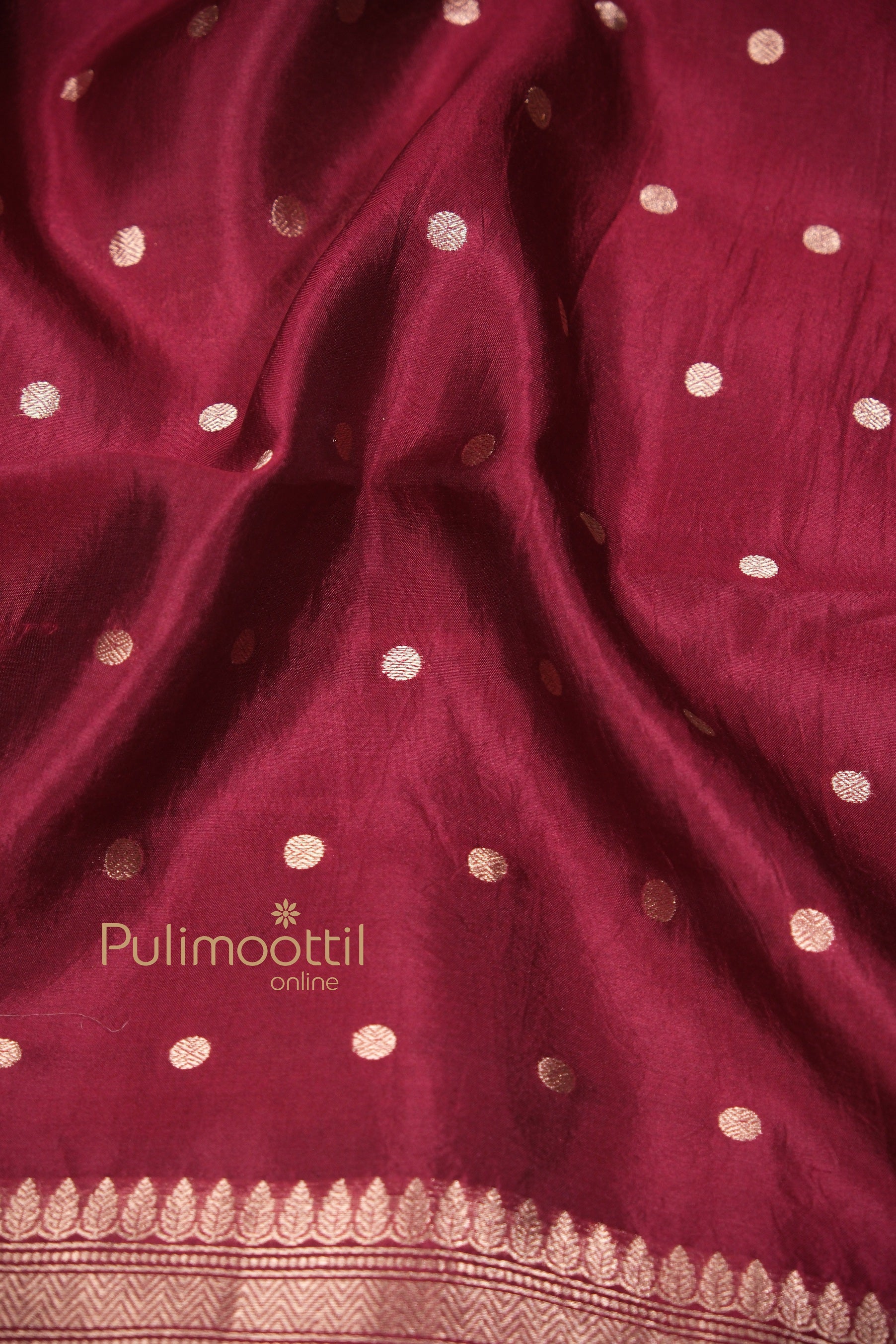Detailed close-up of the maroon bridal mango silk saree showing intricate golden border and soft silk texture – a must-have in the latest wedding saree collection.