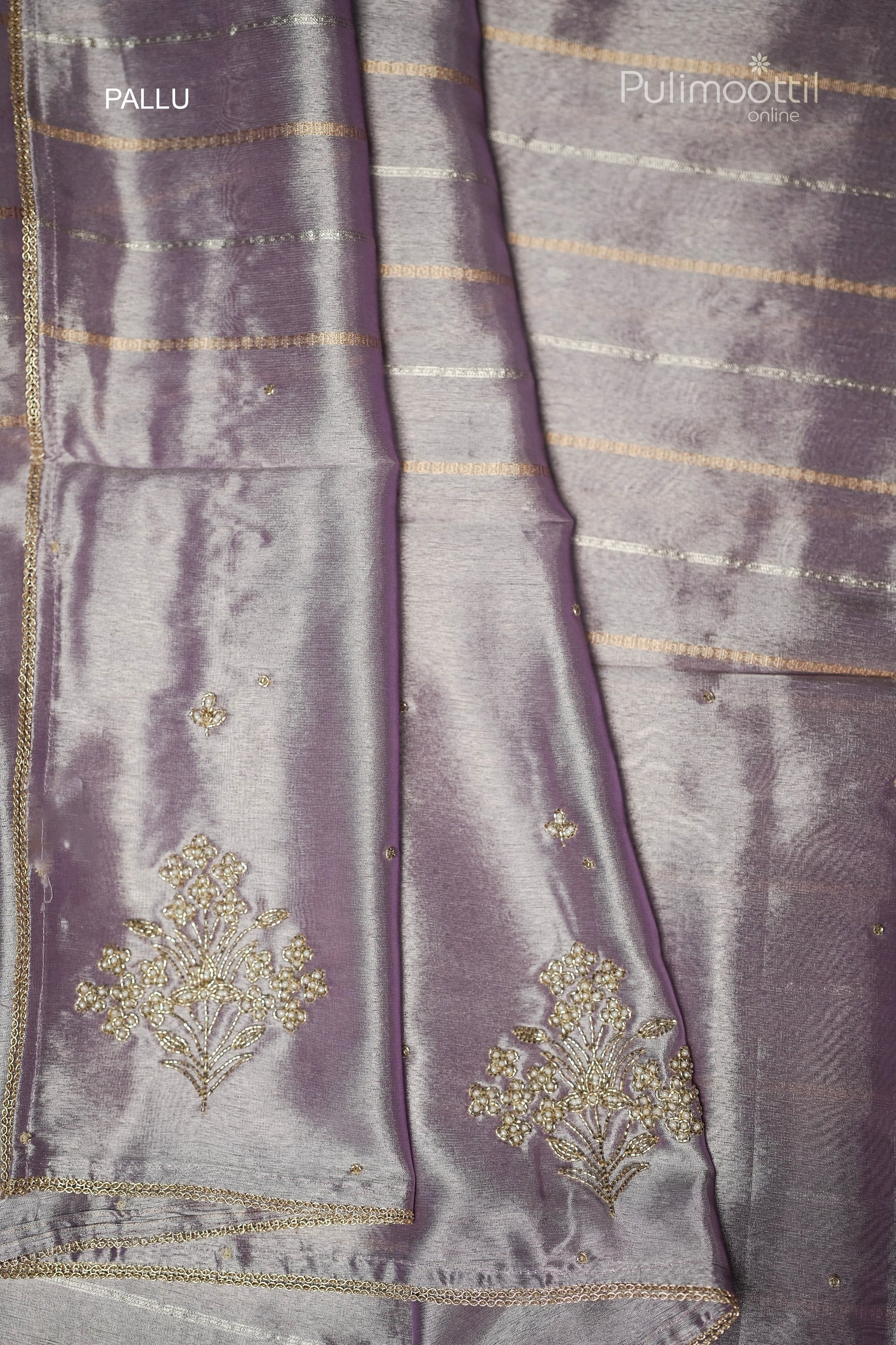 Detailed view of golden lace border and striped pattern on lavender organza saree