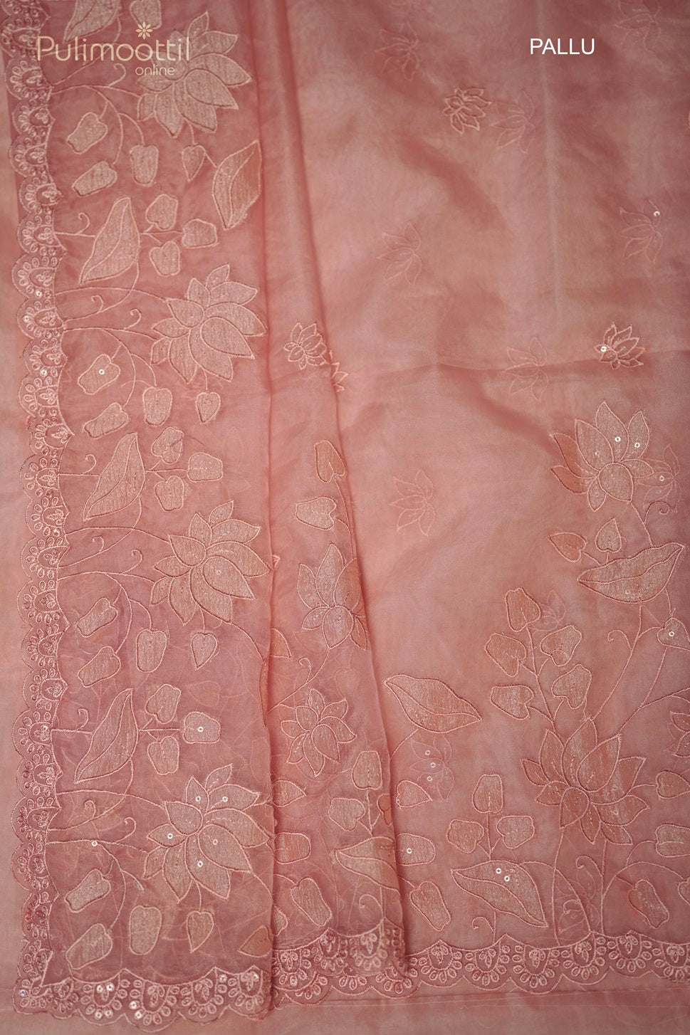 Close-up of peach organza saree pallu with matching lotus embroidery and lotus cut work scallop border, ideal wedding and bridal saree from Thrissur Pulimoottil Silks.