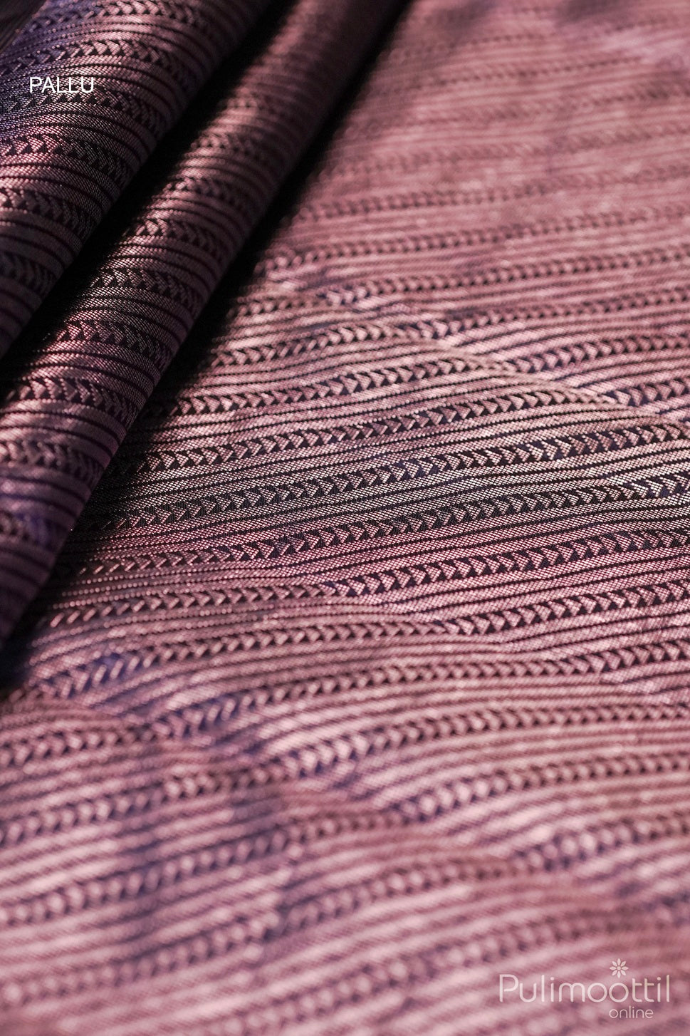 Contrast designer pallu of maroon Kanchipuram saree with intricate rose gold zari patterns.
