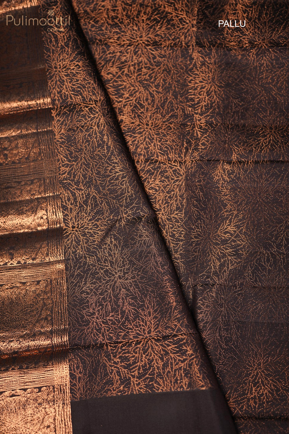 Close-up of the designer pallu of the black Kanchipuram soft silk saree with intricate gold zari work.