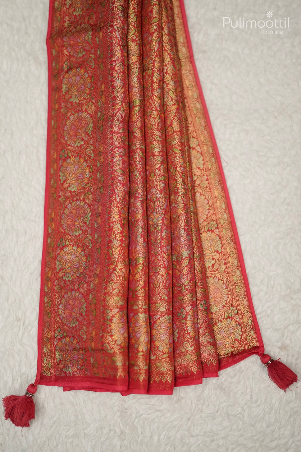 Close-up of vertical striped border on pastel multishaded organza fancy saree, showcasing golden buttas and elegant design for bridal and wedding sarees.