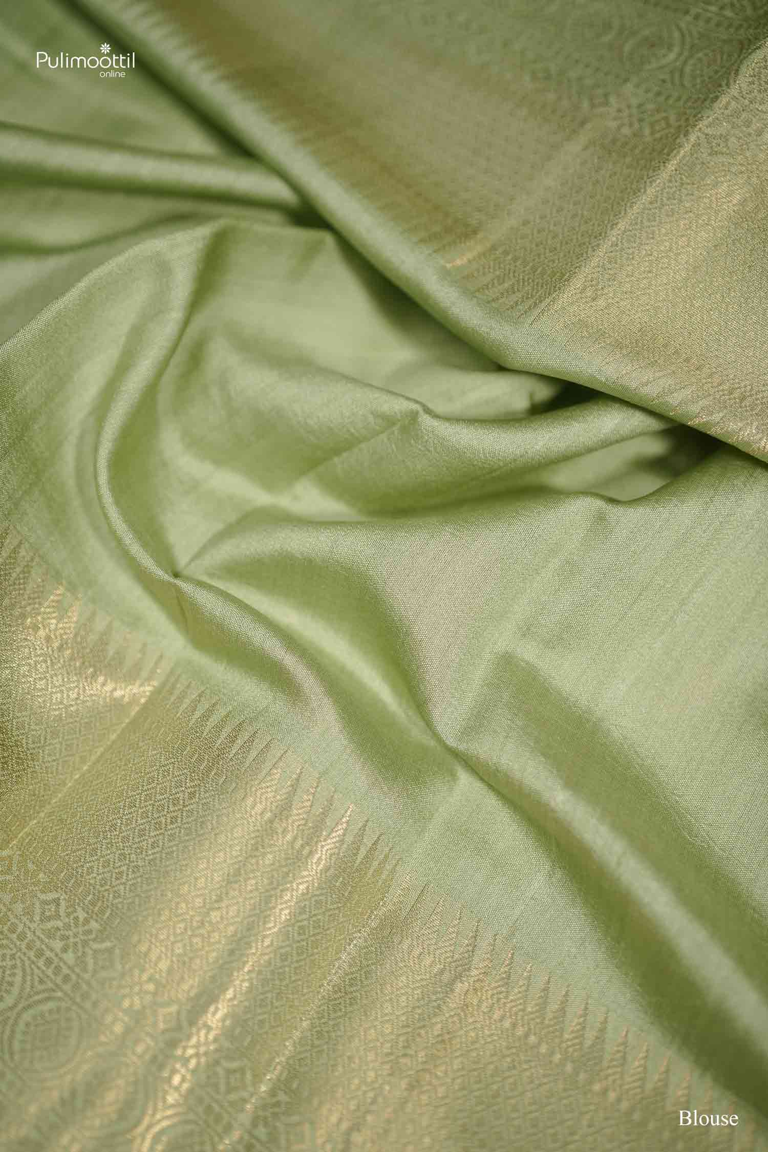 Textural close-up of the Pistachio Green Soft Silk Saree fabric folds, emphasizing the subtle sheen and the intricate woven diamond patterns